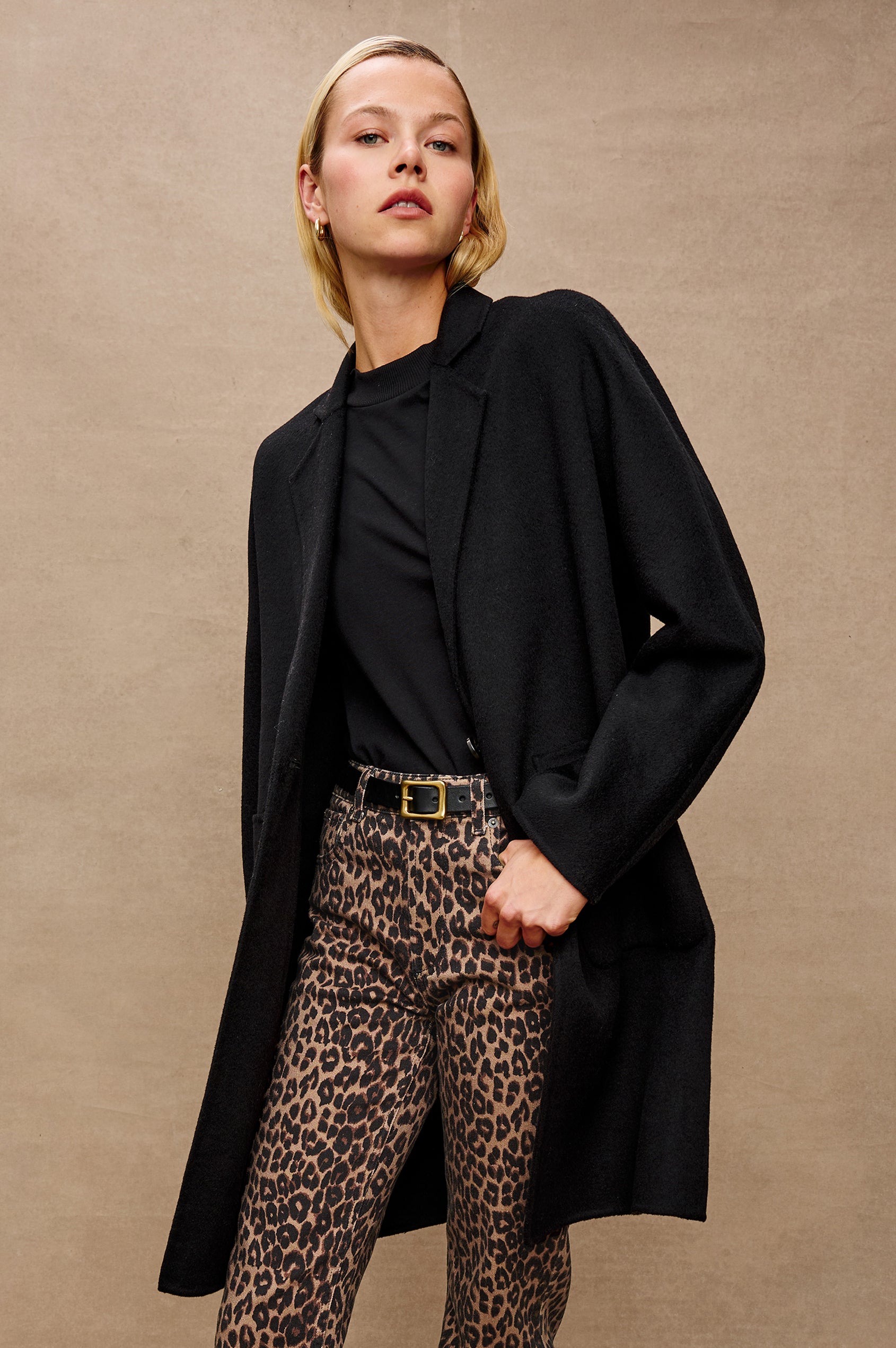 Everest Mid-Thigh Length Coat with Single Button Closure, Notched Lapels and Front Patch Pockets in Black Colorway -Stylized Front View Featured on Model