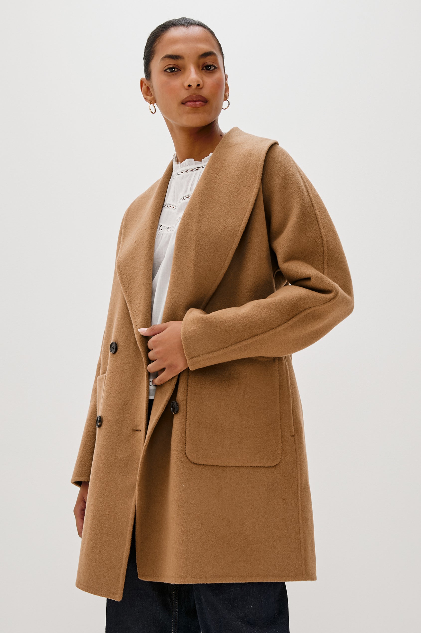 Nily Mid-Thigh Length, Double-Breasted Coat with Two Button Closure, Two Front Patch Pockets and a Shaw Collar in Camel Colorway - Front View Featured on Model 