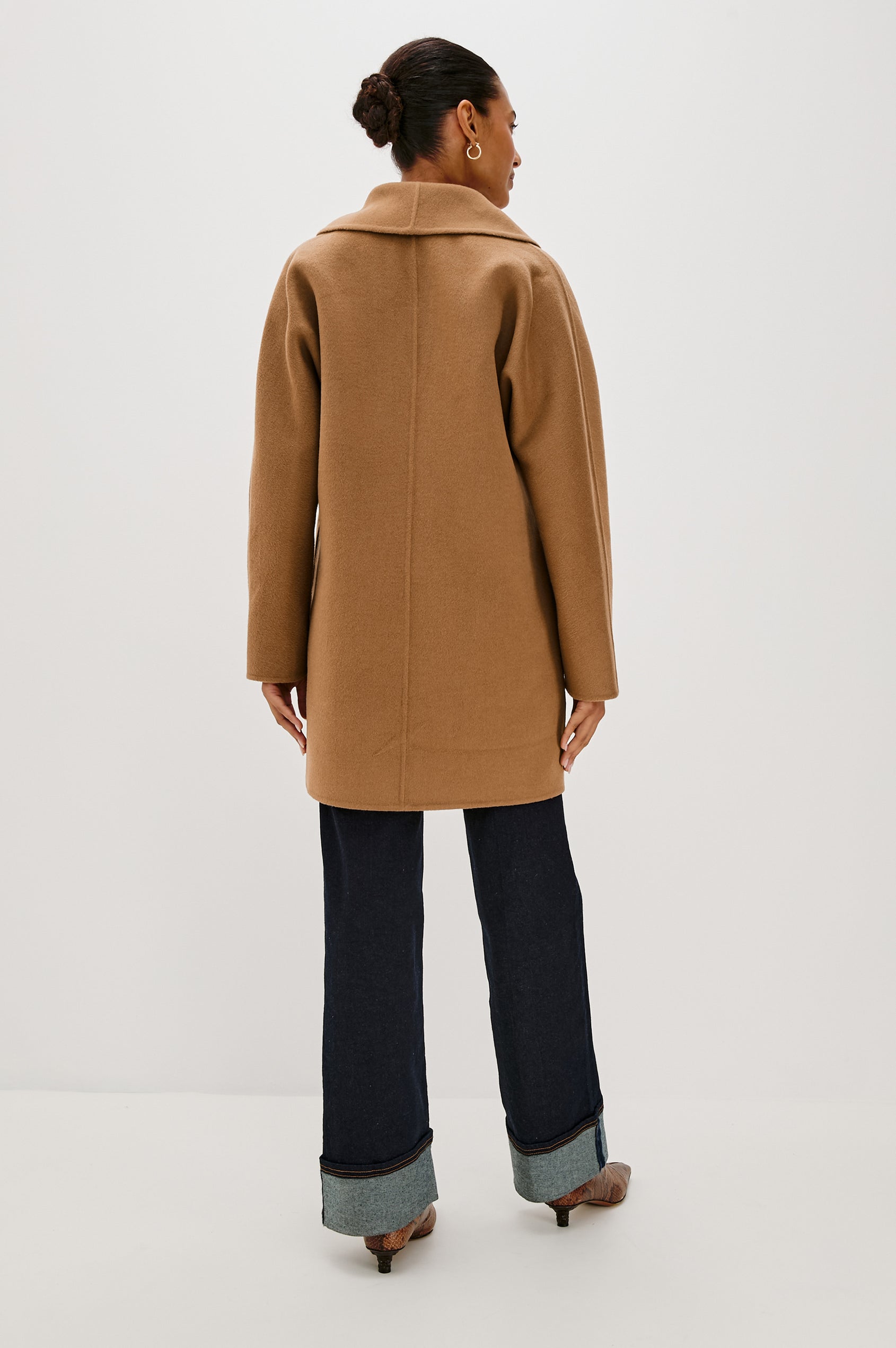 Nily Mid-Thigh Length, Double-Breasted Coat with Two Button Closure, Two Front Patch Pockets and a Shaw Collar in Camel Colorway - Back View Featured on Model 