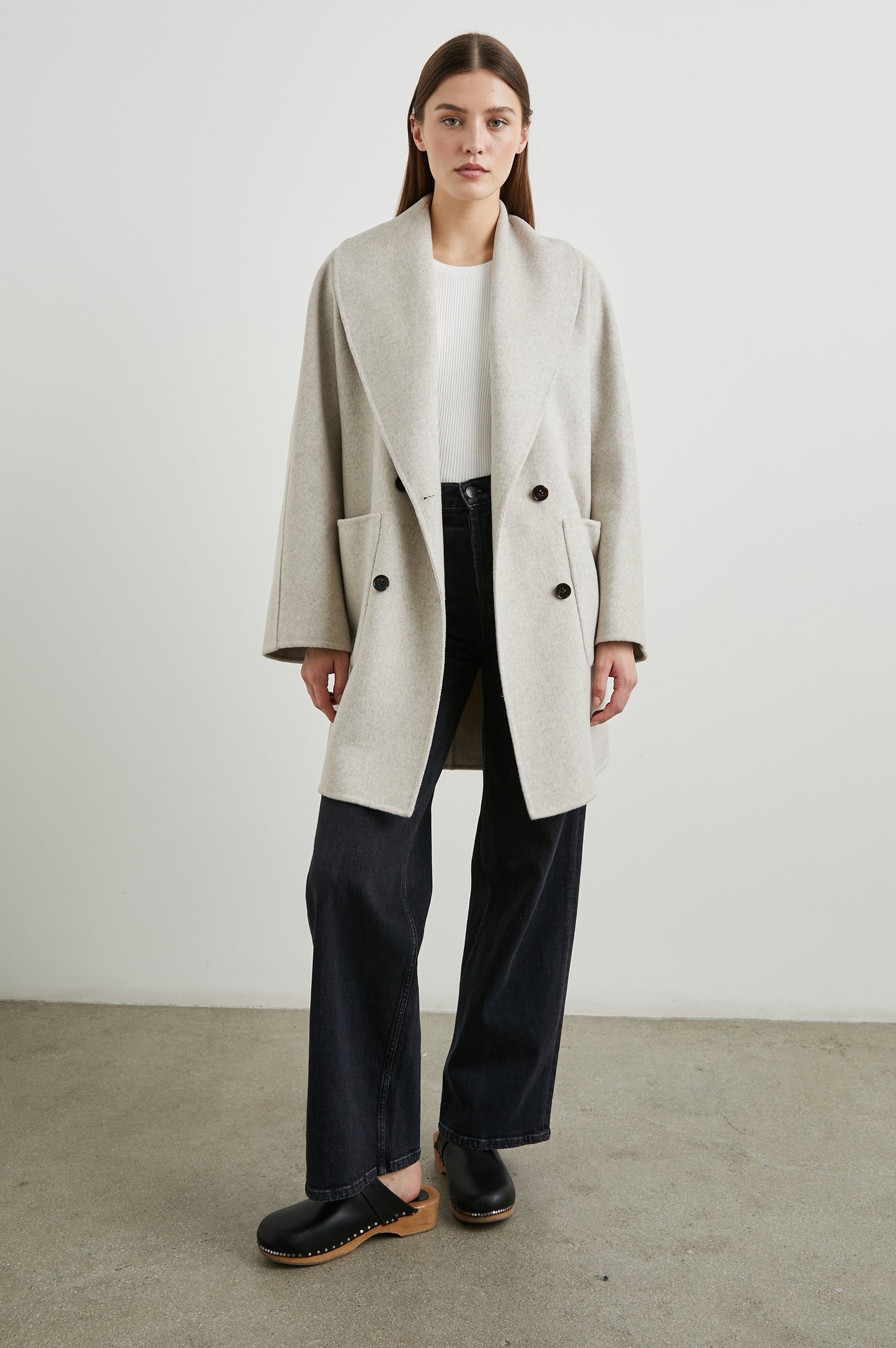 Nily Mid-Thigh Length, Double-Breasted Coat with Two Button Closure, Two Front Patch Pockets and a Shaw Collar in Oatmeal Colorway - Front Full Body View Featured on Model 