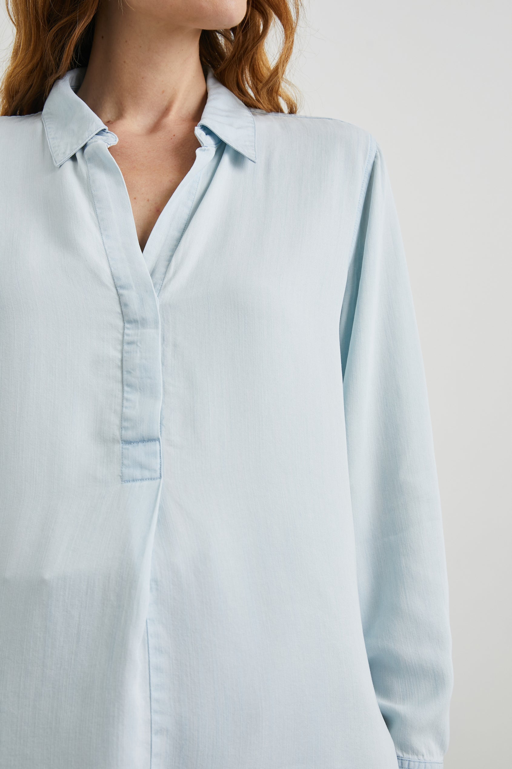 Nissa Long-Sleeve Top with a Partially Sealed Placket, a Collar and Button Cuffs in Light Vintage Colorway, a Blue - Front View Featured on Model