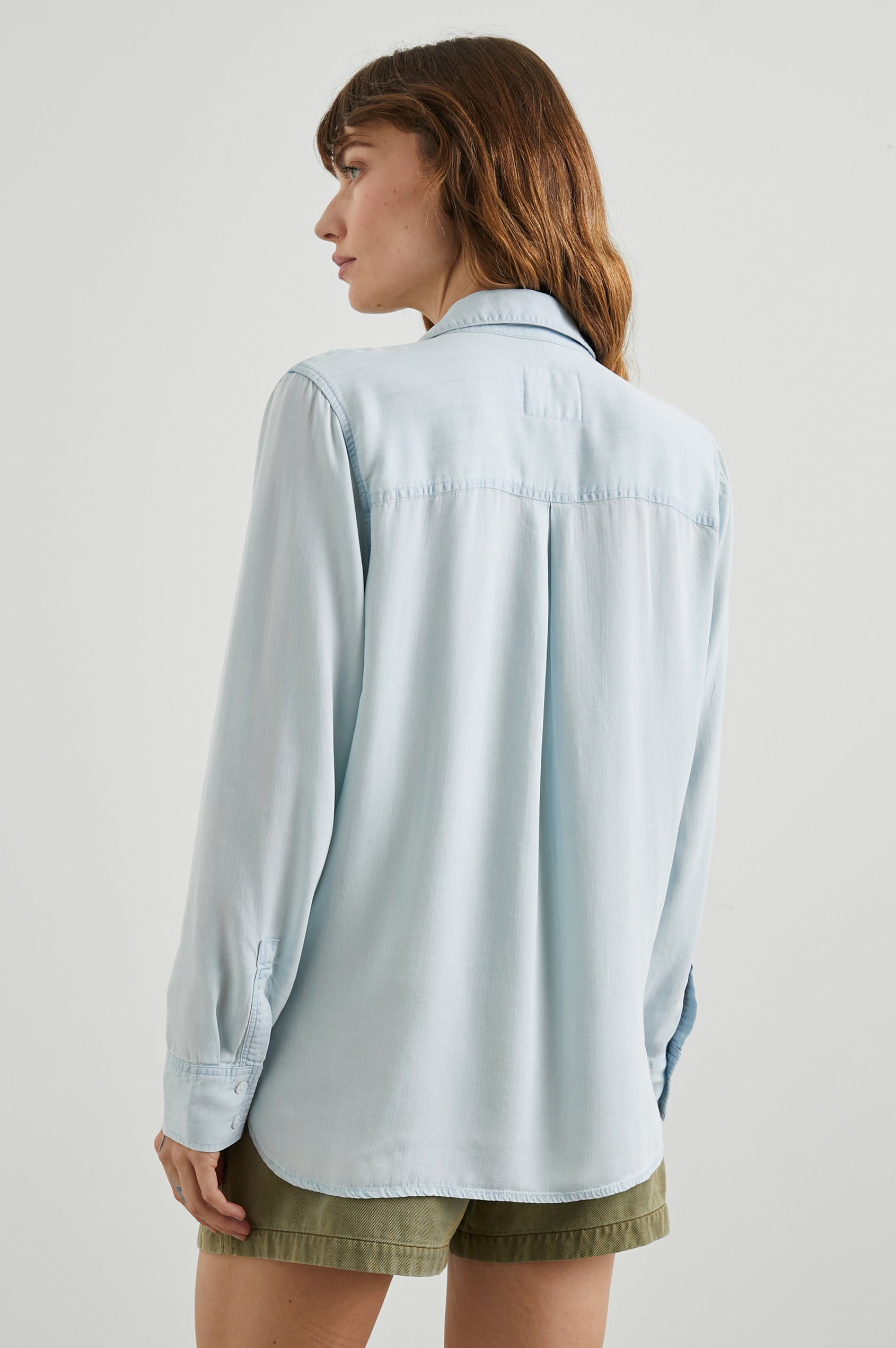 Nissa Long-Sleeve Top with a Partially Sealed Placket, a Collar and Button Cuffs in Light Vintage Colorway, a Blue - Back View Featured on Model