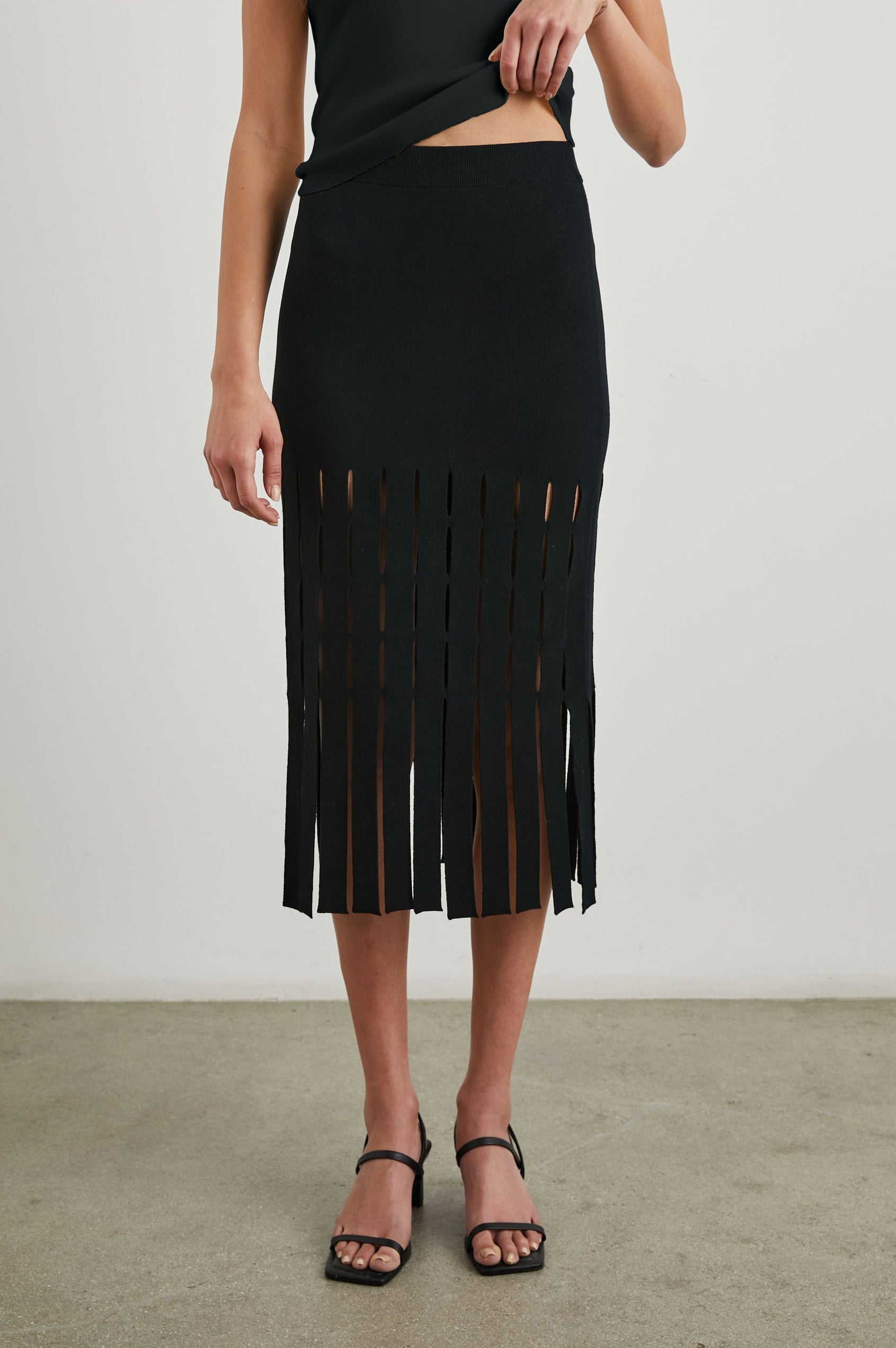 Nola Midi Skirt with Cutouts from the Mid-Thigh Down and Ending in Cut Panels in Black Colorway - Front View Featured on Model 