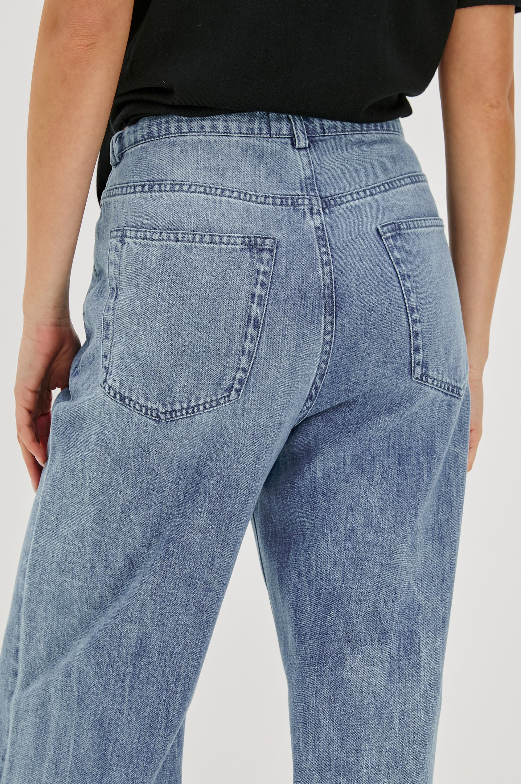 Normandie Lightweight 5-Pocket Denim Wide Leg Pant with front zipper button fly and a drawstring tie at waist in Antique Blue Colorway. Back View Featured on Model.