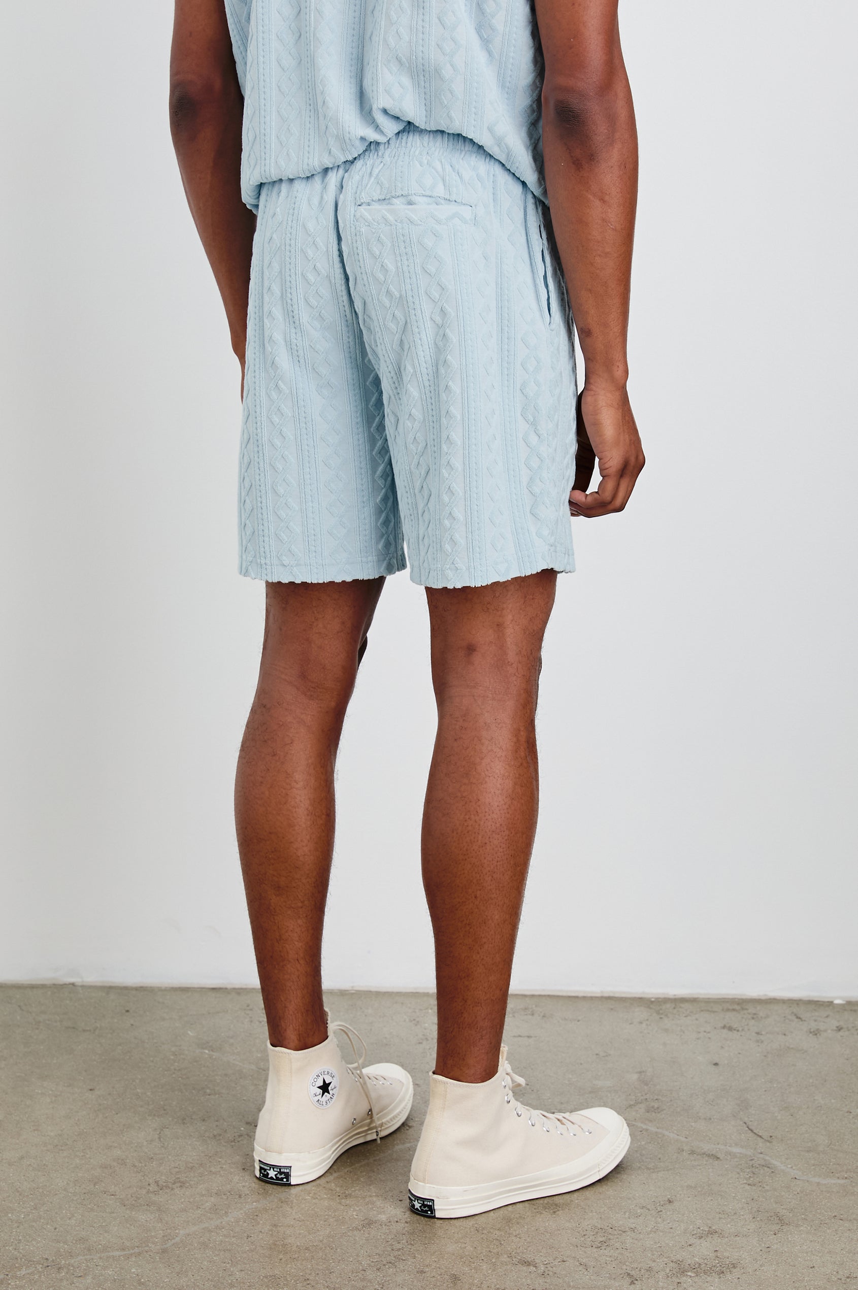 Nova Shorts with a Drawstring Waist, a Raised Jacquard Pattern, Two Front Pockets and a Back Patch Pocket in Coastal Blue Colorway - Back View Featured on Model
