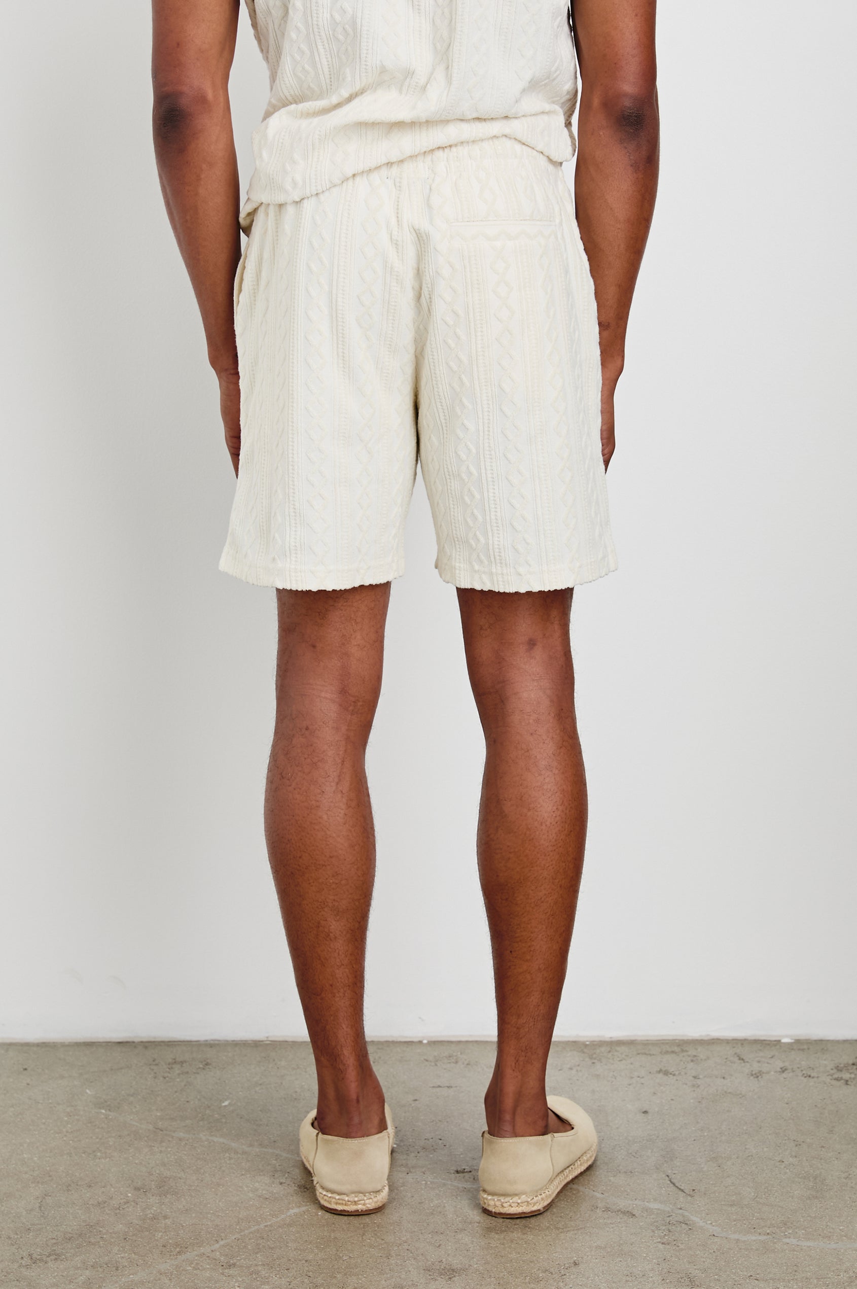 Nova Shorts with a Drawstring Waist, a Raised Jacquard Pattern, Two Front Pockets and a Back Patch Pocket in Ecru Colorway - Back View Featured on Model