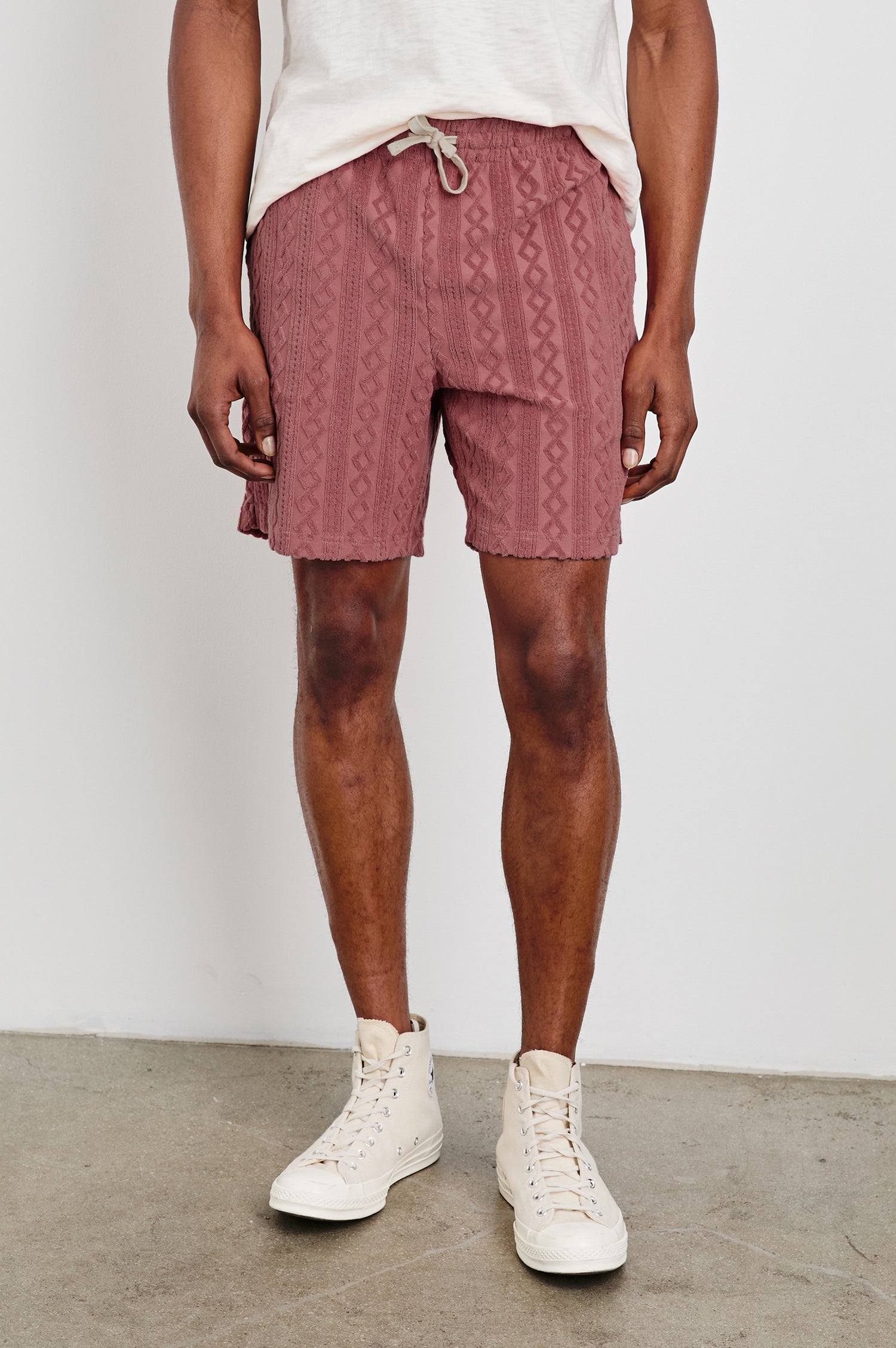 Nova terry shorts with raised jacquard pattern and front drawstring in Faded Red - front view on model