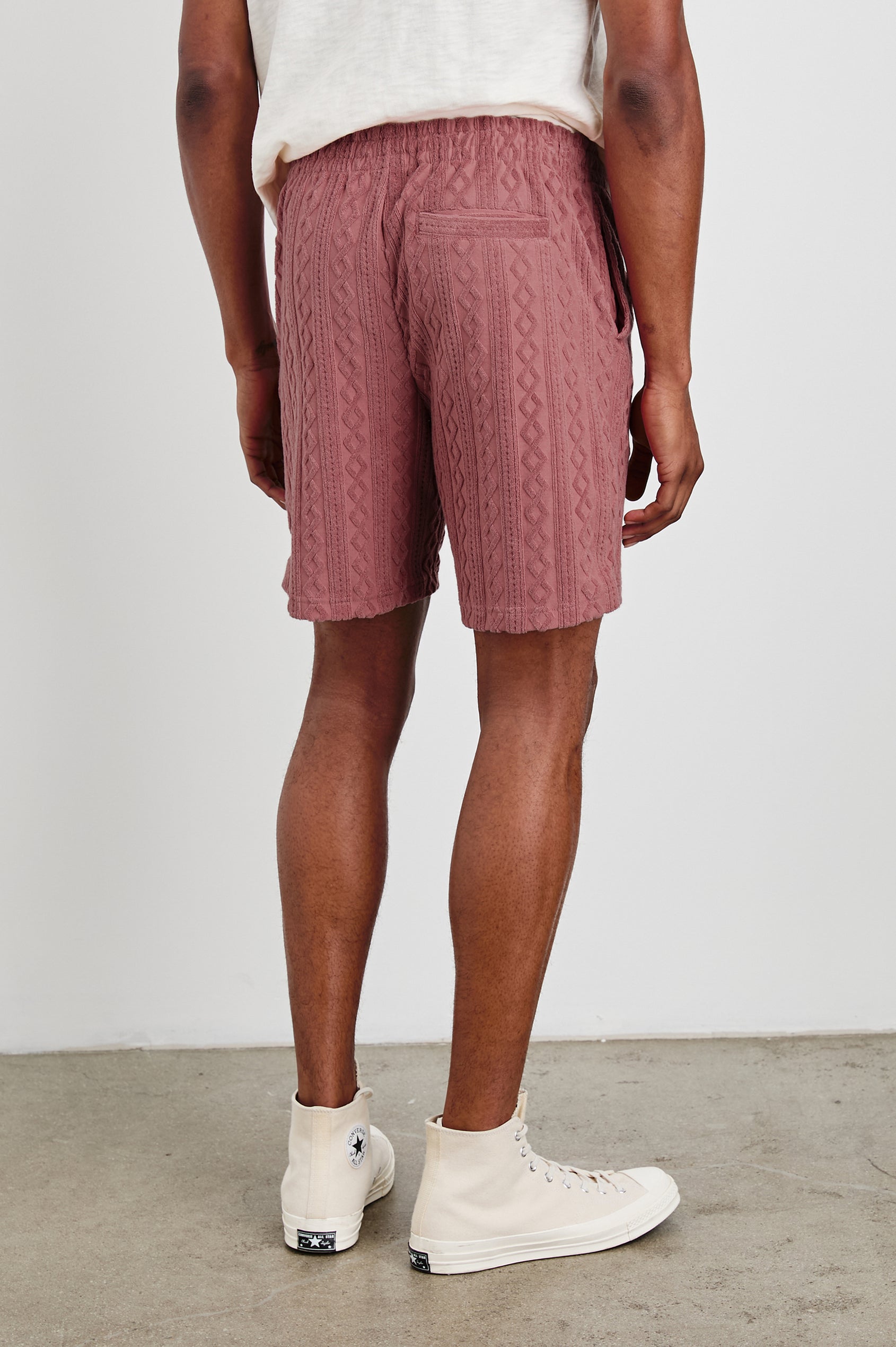 Nova terry shorts with raised jacquard pattern and front drawstring in Faded Red - back view on model with pockets