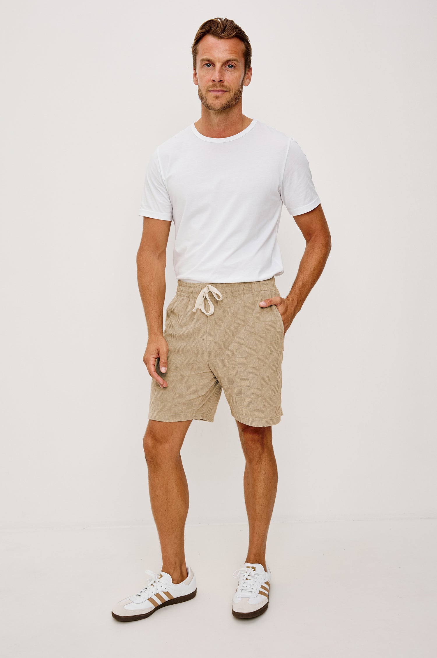 Nova Short in French Terry With Raised Jacquard Pattern, Side Pockets, and Drawstring Waist Ties in Grange Craft Paper Colorway - Full Body Front View Featured on Model
