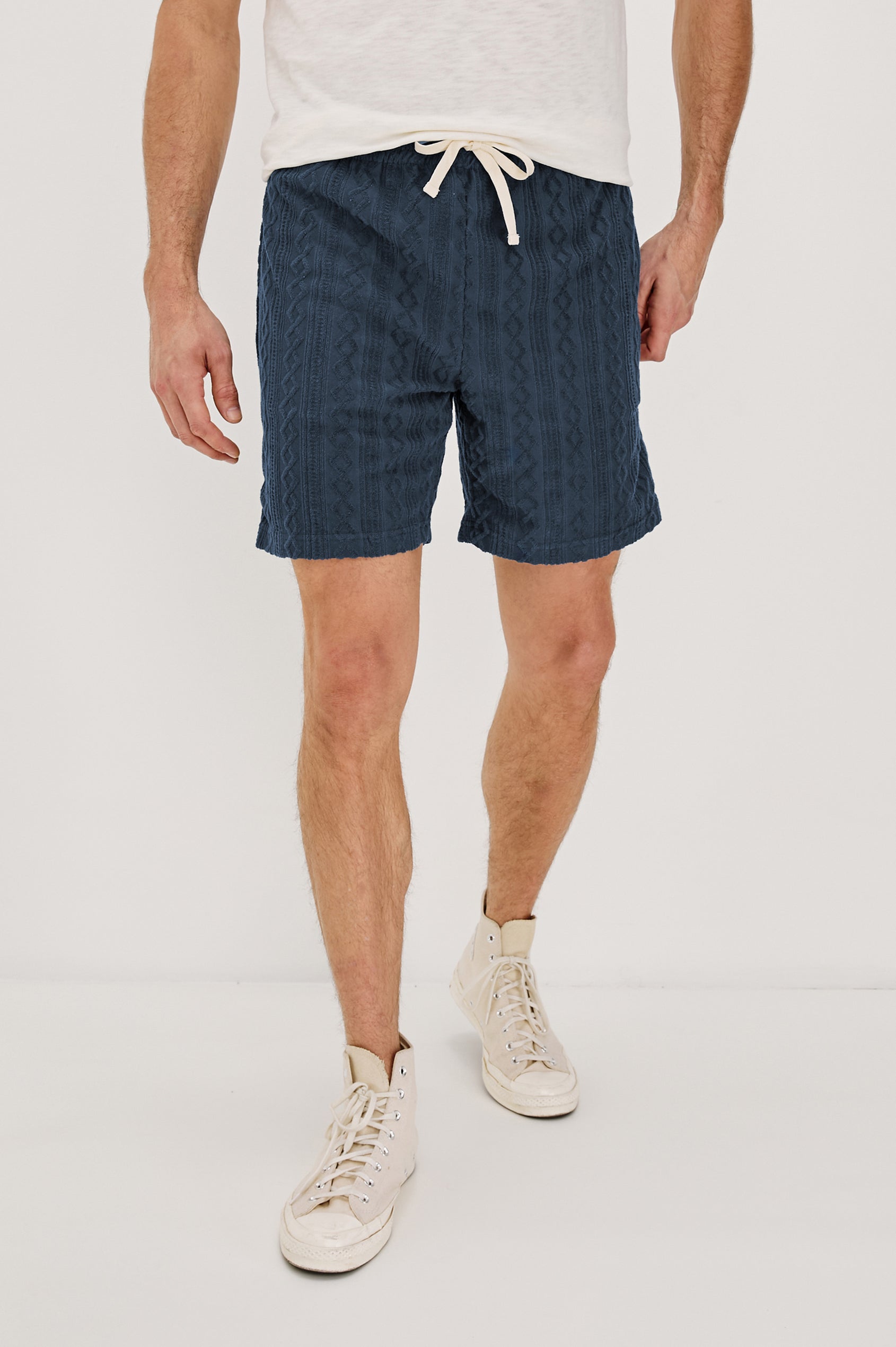 Nova Shorts with a Drawstring Waist, a Raised Jacquard Pattern, Two Front Pockets and a Back Patch Pocket in Ecru Colorway - Front View Featured on Model