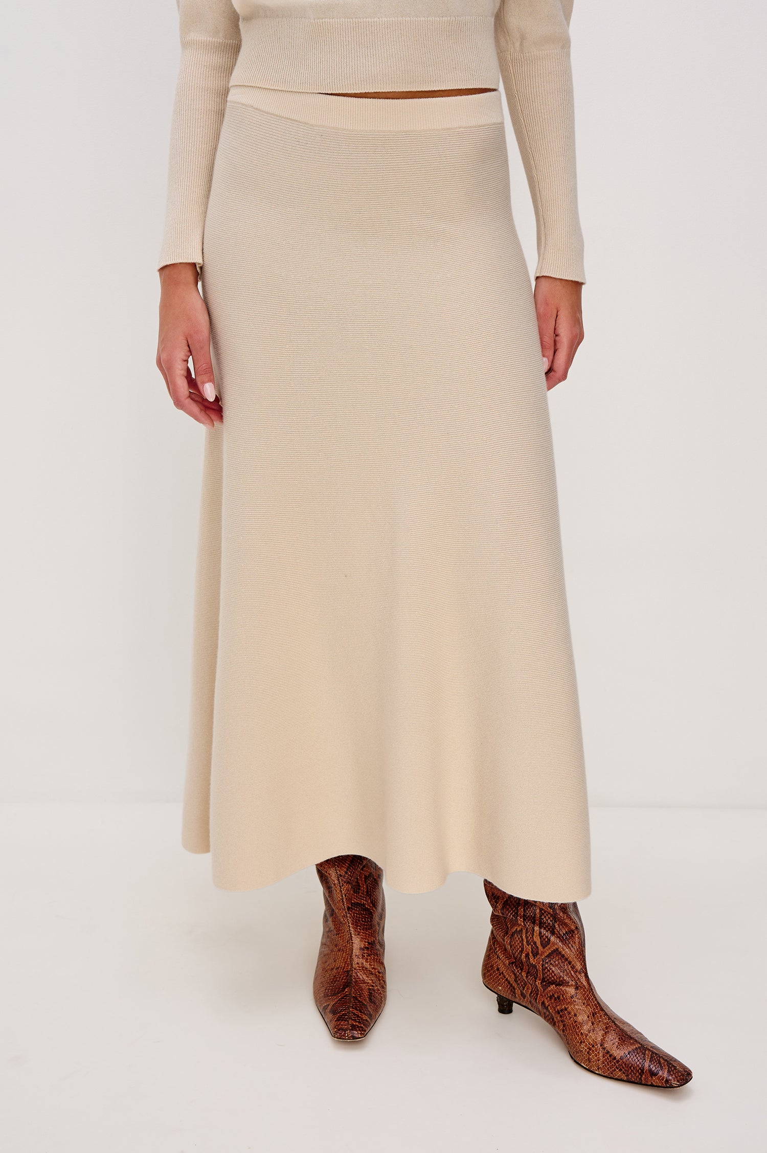 Odita Midi Skirt in Ribbed Wool Blend With High-Waisted Fit, A-Line Silhouette, and Wide Waistband in Ivory Colorway - Lower Body Front View Featured on Model