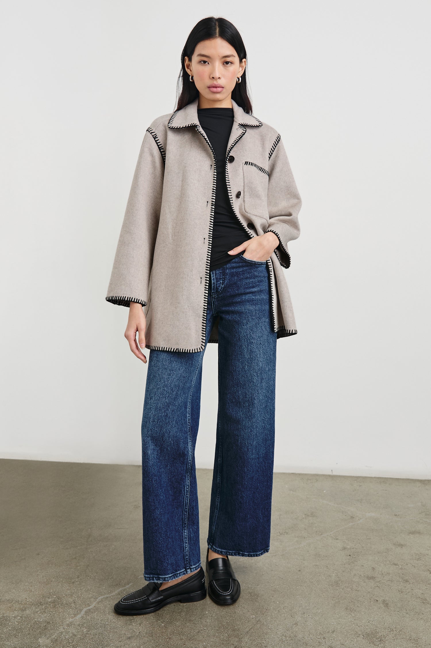 Odyssey Jacket with Four Button Closure and a Chest Patch Pocket in Oatmeal Colorway, with black contrast stitching - Front Full Body View Featured on Model