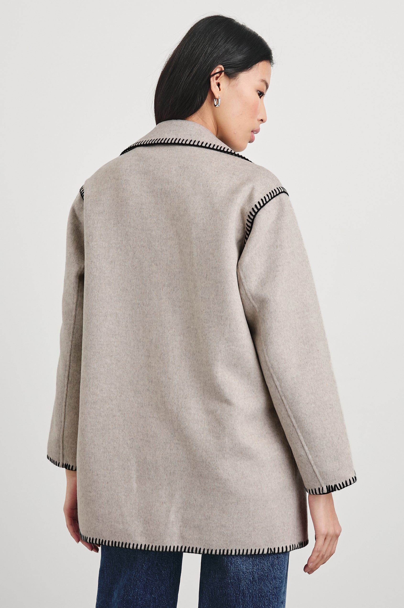 Odyssey Jacket with Four Button Closure and a Chest Patch Pocket in Oatmeal Colorway, with black contrast stitching - Back View Featured on Model