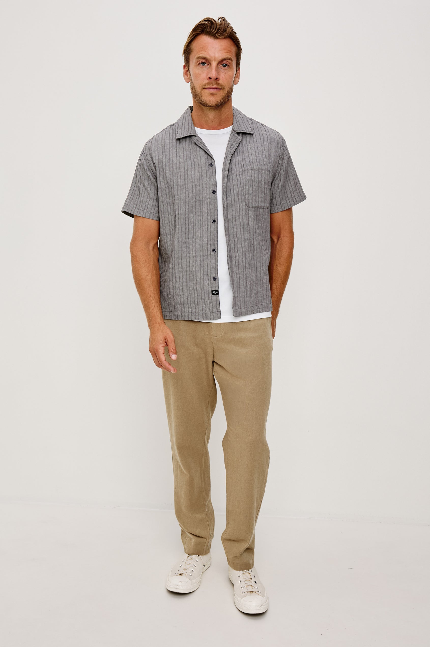 Ohana Button-Up Shirt in Textured Shirting WIth Short Sleeves, Collar, and Relaxed Fit in Charcoal Chambray Colorway - Full Body Front View Featured on Model