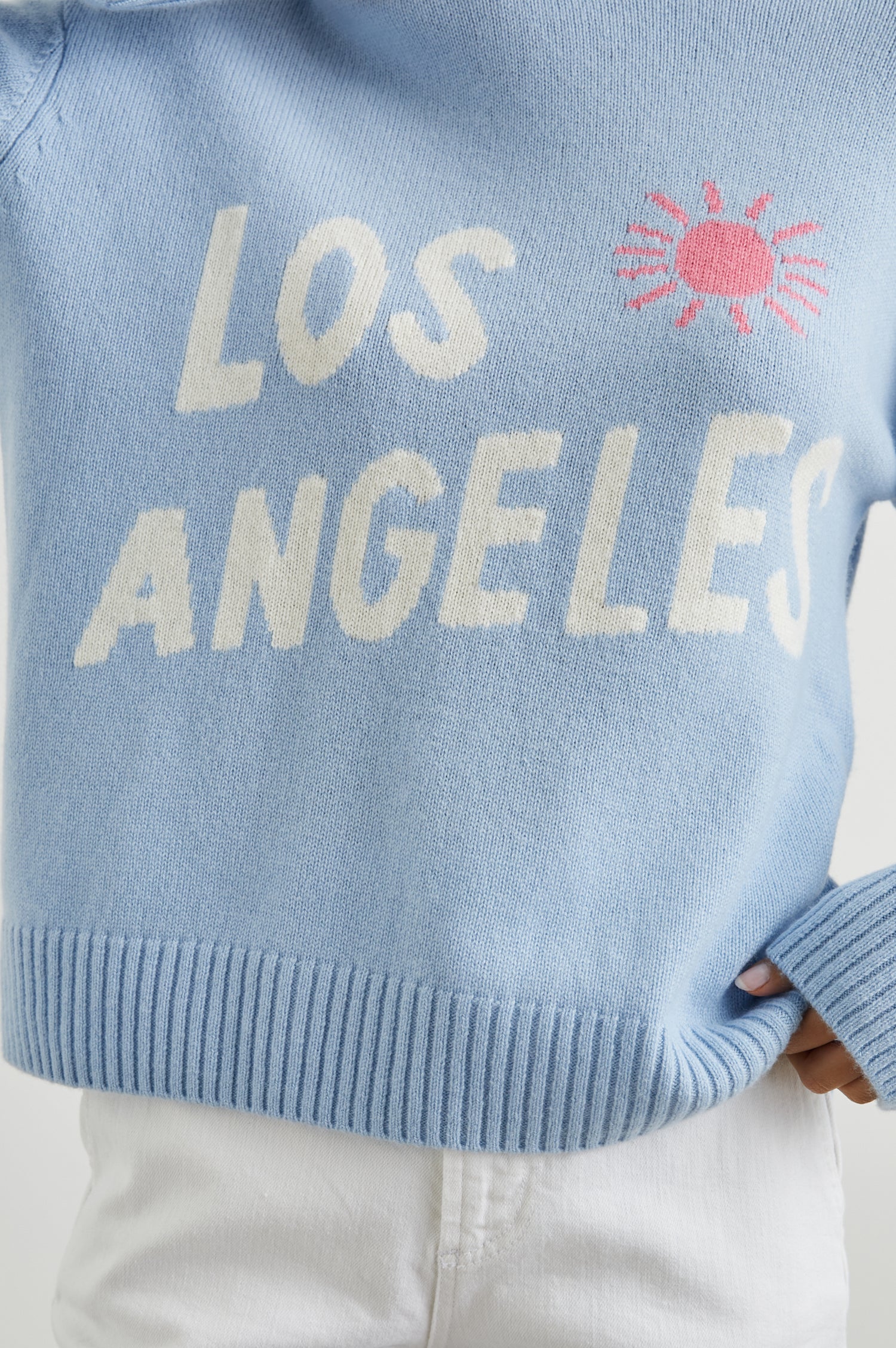 Olivia Long-Sleeve Sweater with a Crew Neck, a Pink Sun and Gold Palm Trees and the White Text, Los Angeles, in Los Angeles Blue Colorway - Front View Featured on Model  