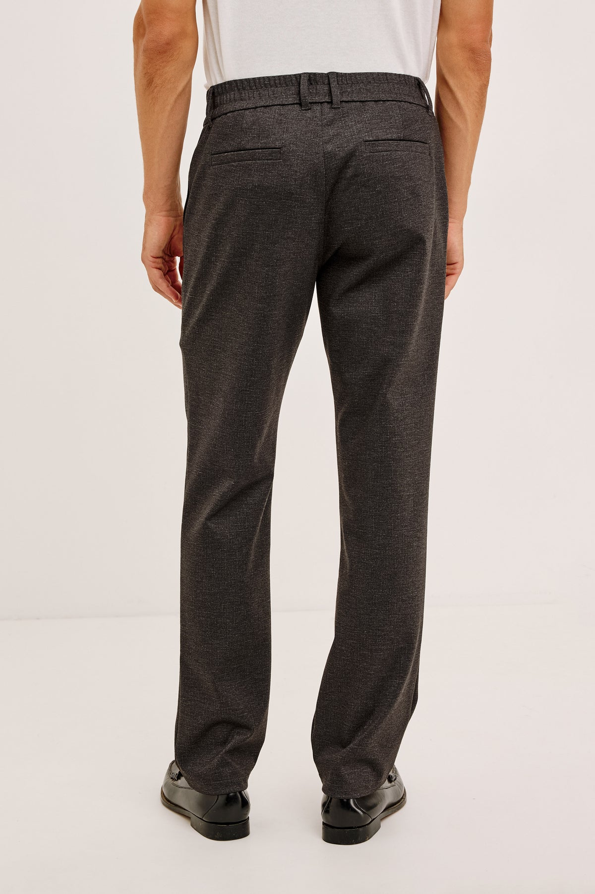 Olivier Pant in Stretch Ponte Knit With Slim Legs, Clean Front Waistband With Belt Loops, Elasticated Sides and Back, Front Zip Fly, Side Slash Pockets, and Back Welt Pockets in Umber Colorway - Lower Body Back View Featured on Model