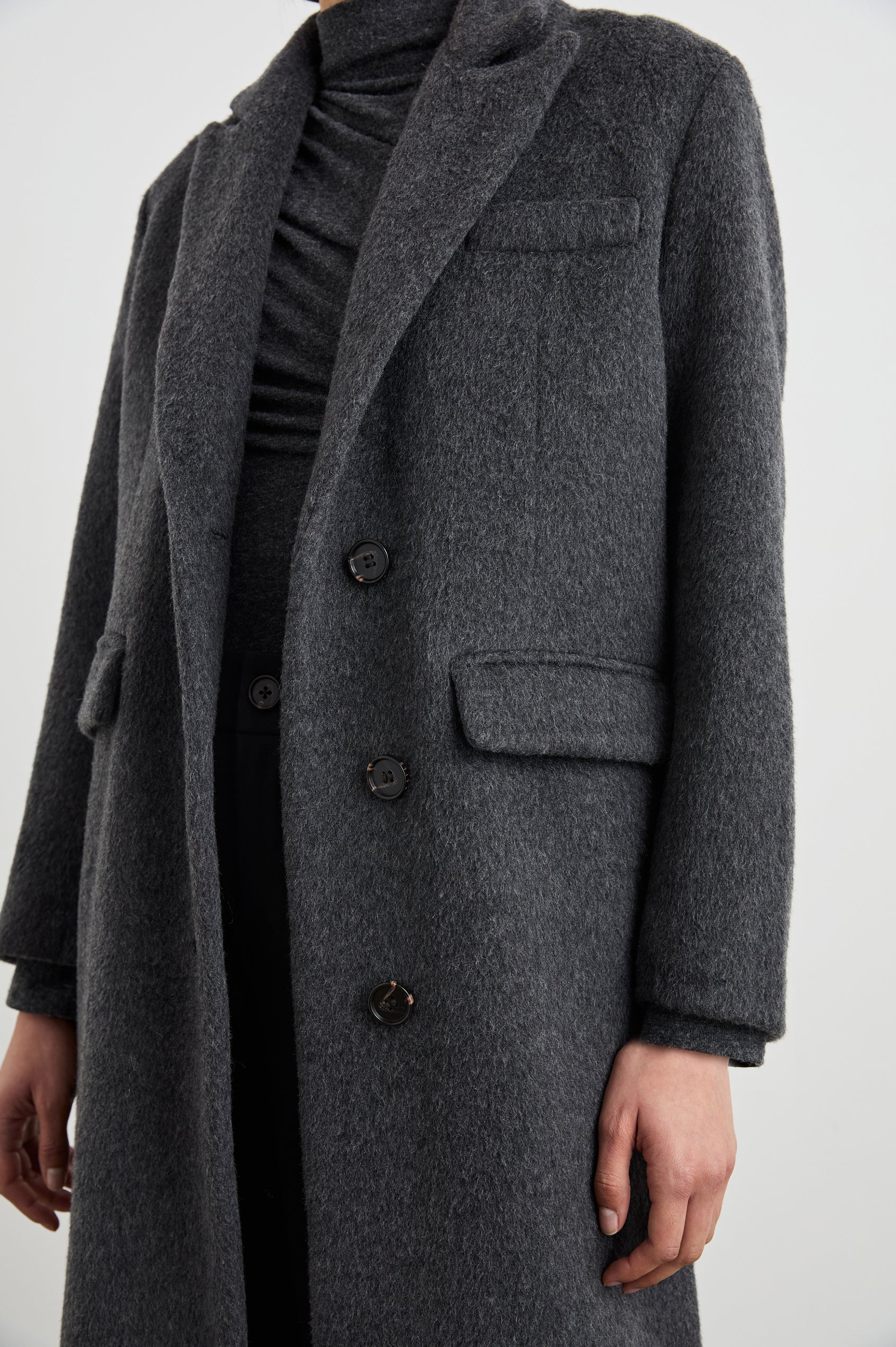 Opera Below-the-Knee Length Coat with V Neck, Three-Button Closure and Two Front Flap Patch Pockets in Charcoal Colorway - Front View Featured on Model