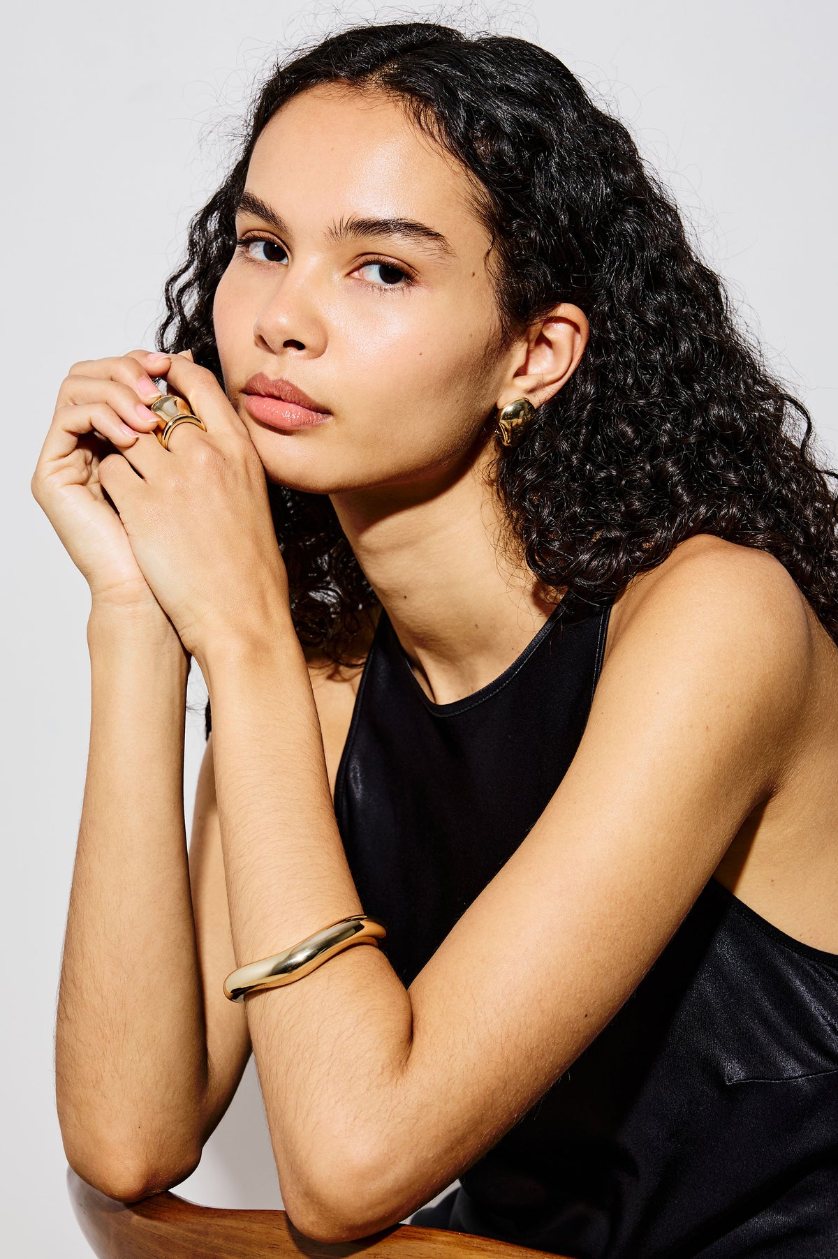 Organic Shaped Cuff Bracelet With Open Back and Engraved Interior Rails Logo in Gold Colorway - Upper Body Front View Featured on Model