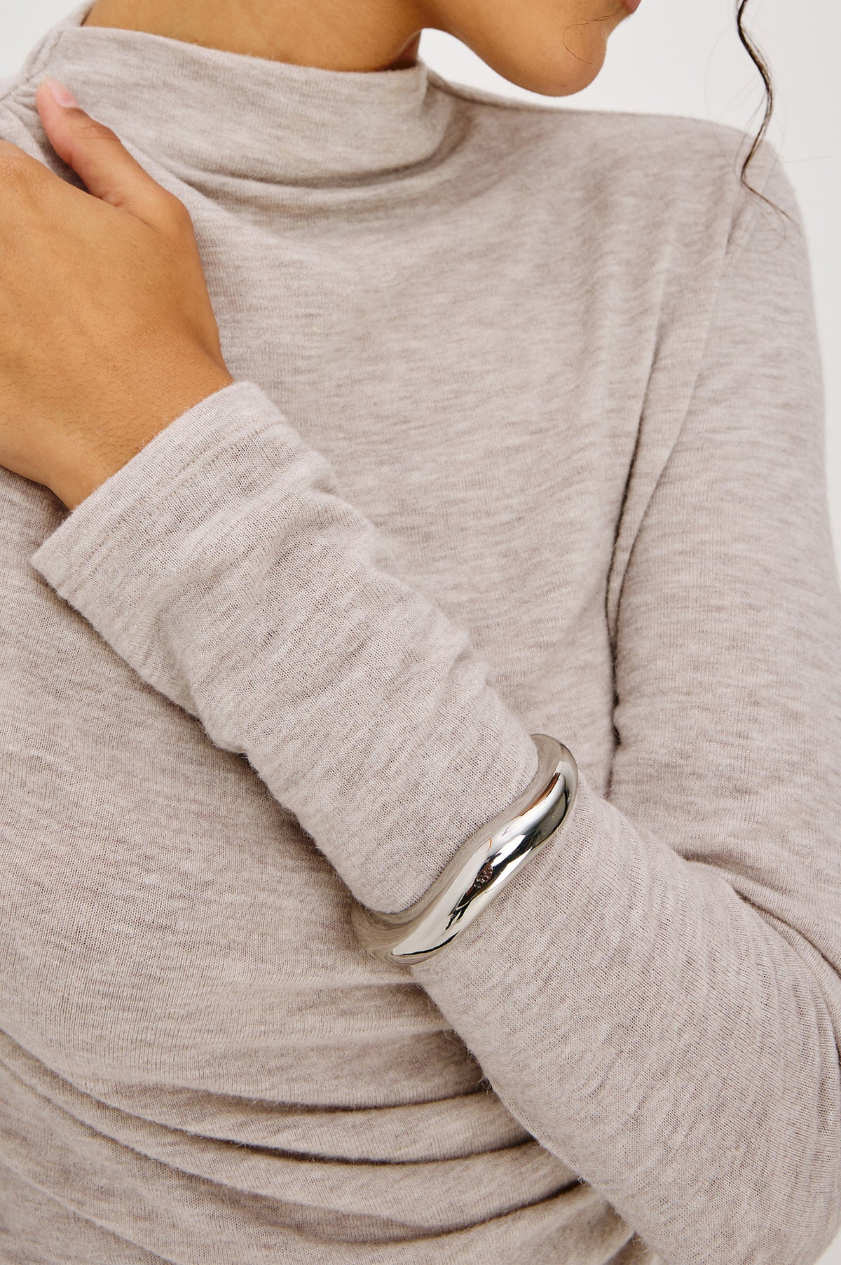 Organic Shaped Cuff Bracelet With Open Back and Engraved Interior Rails Logo in Silver Colorway - Upper Body Close Up View Featured on Model
