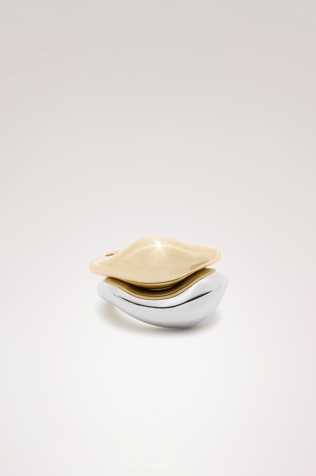 Stacked Ring Set in Mixed Metal Finish With Organic Sculptural Shape and Interior Engraved Rails Logo in Silver Gold Colorway - Flat Lay Product iew Featured