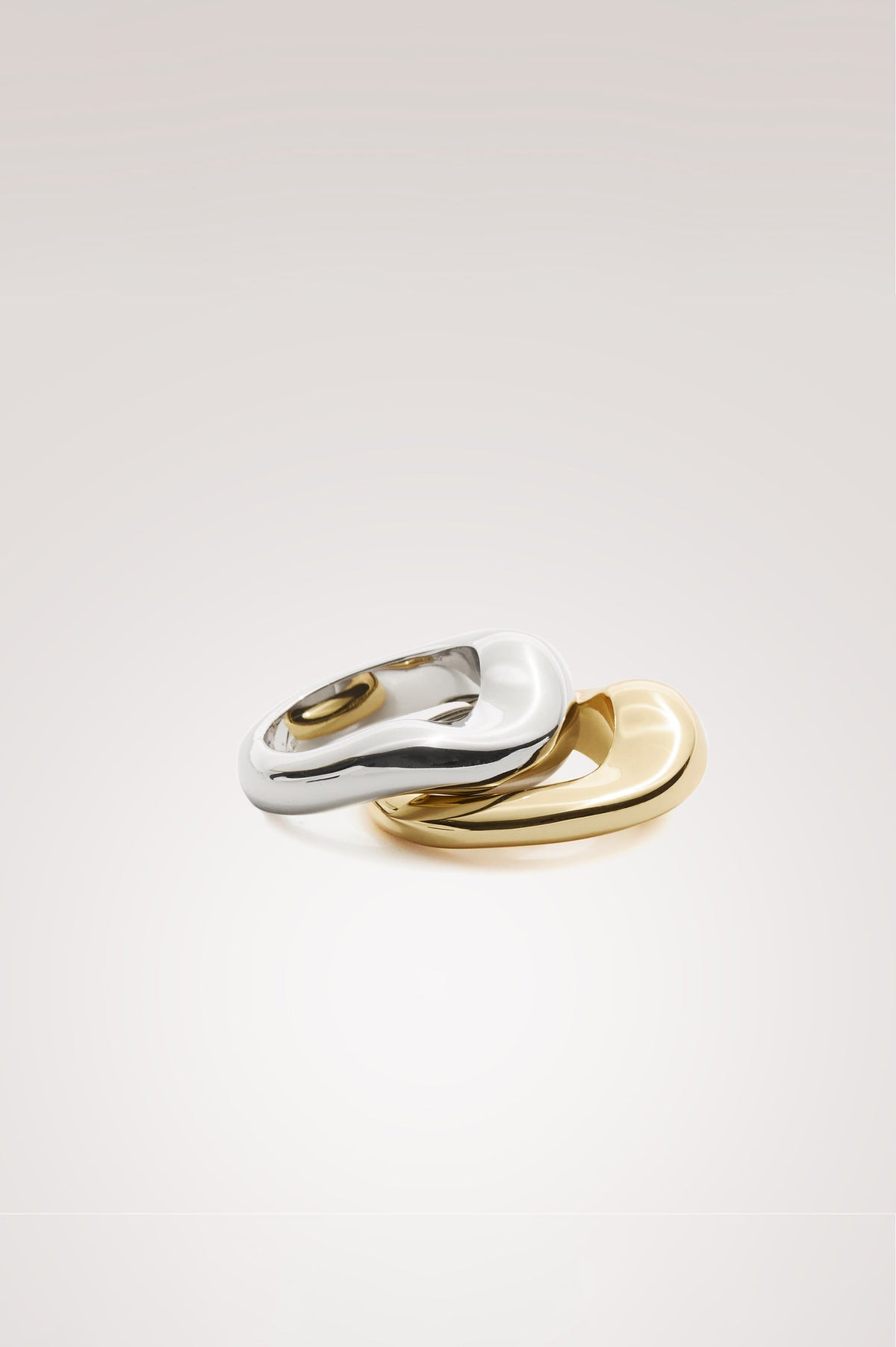 Stacked Ring Set in Mixed Metal Finish With Organic Sculptural Shape and Interior Engraved Rails Logo in Silver Gold Colorway - Flat Lay Product iew Featured