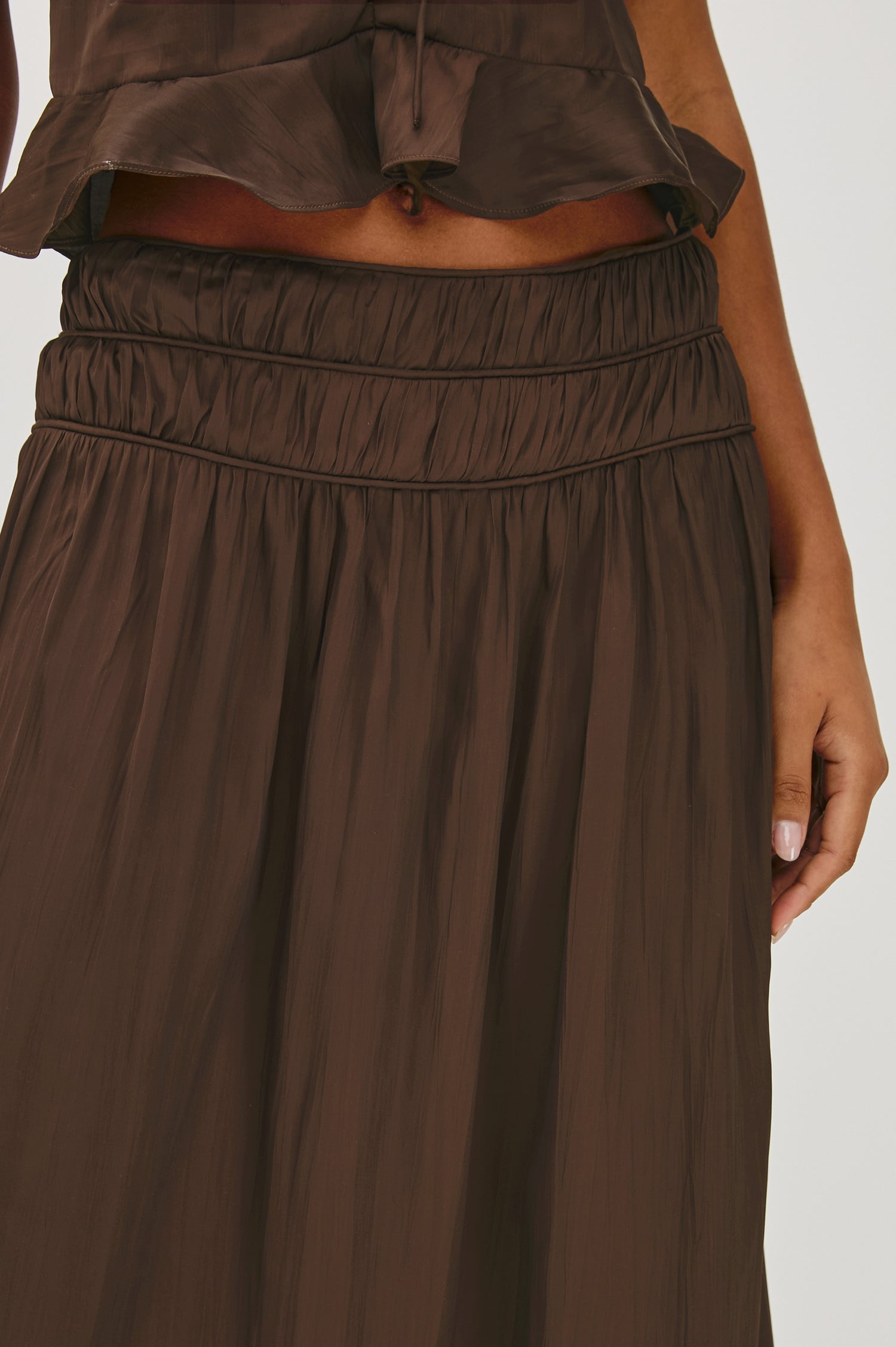 Nara midi skirt in Espresso brown with a flowing A-line cut and a comfortable elasticated waist - front full body view featured on model.