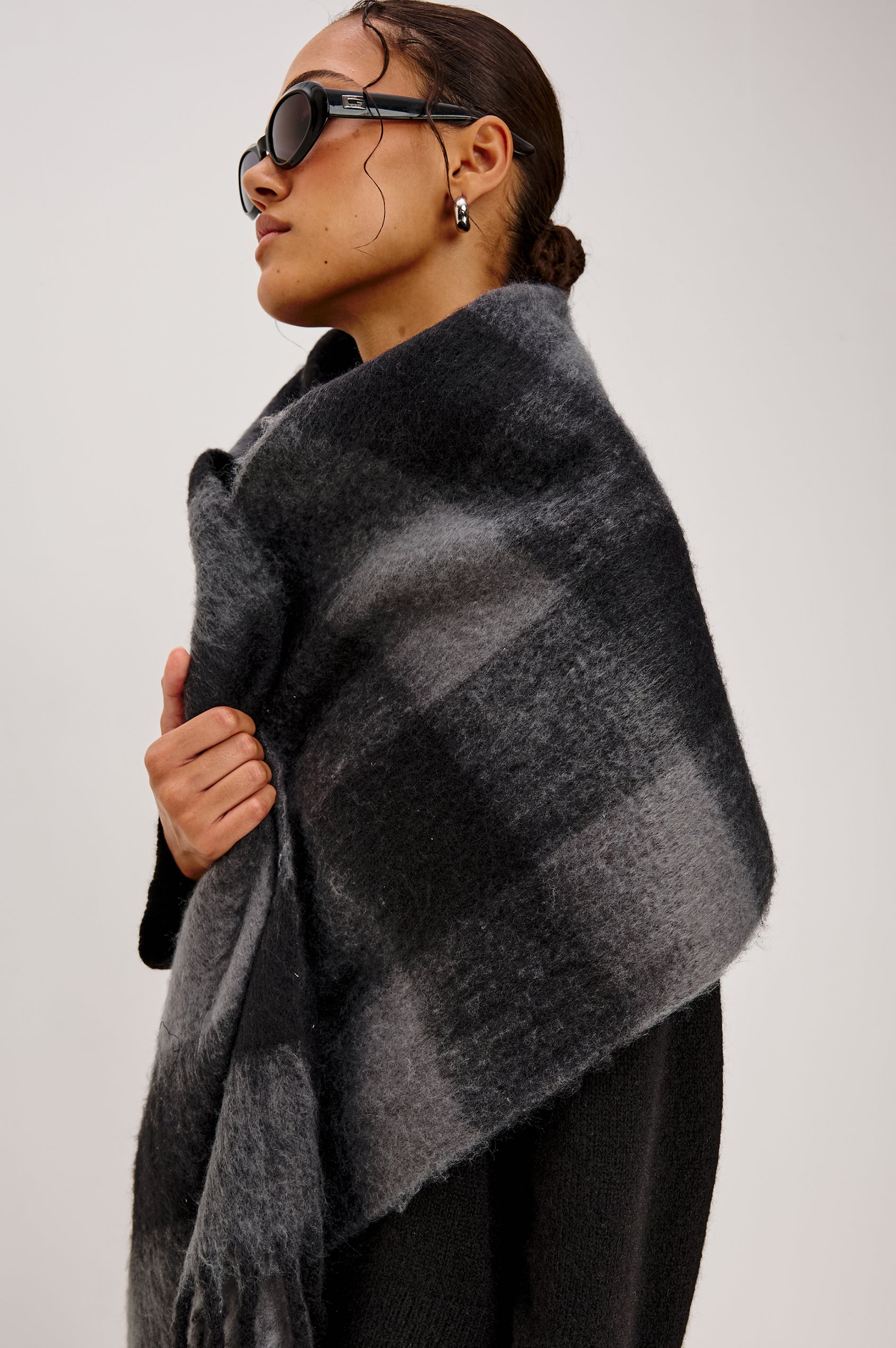 Oslo Scarf with Twisted Tassels and a Checkered Pattern in Charcoal Black Colorway - Front Side View Featured on Model