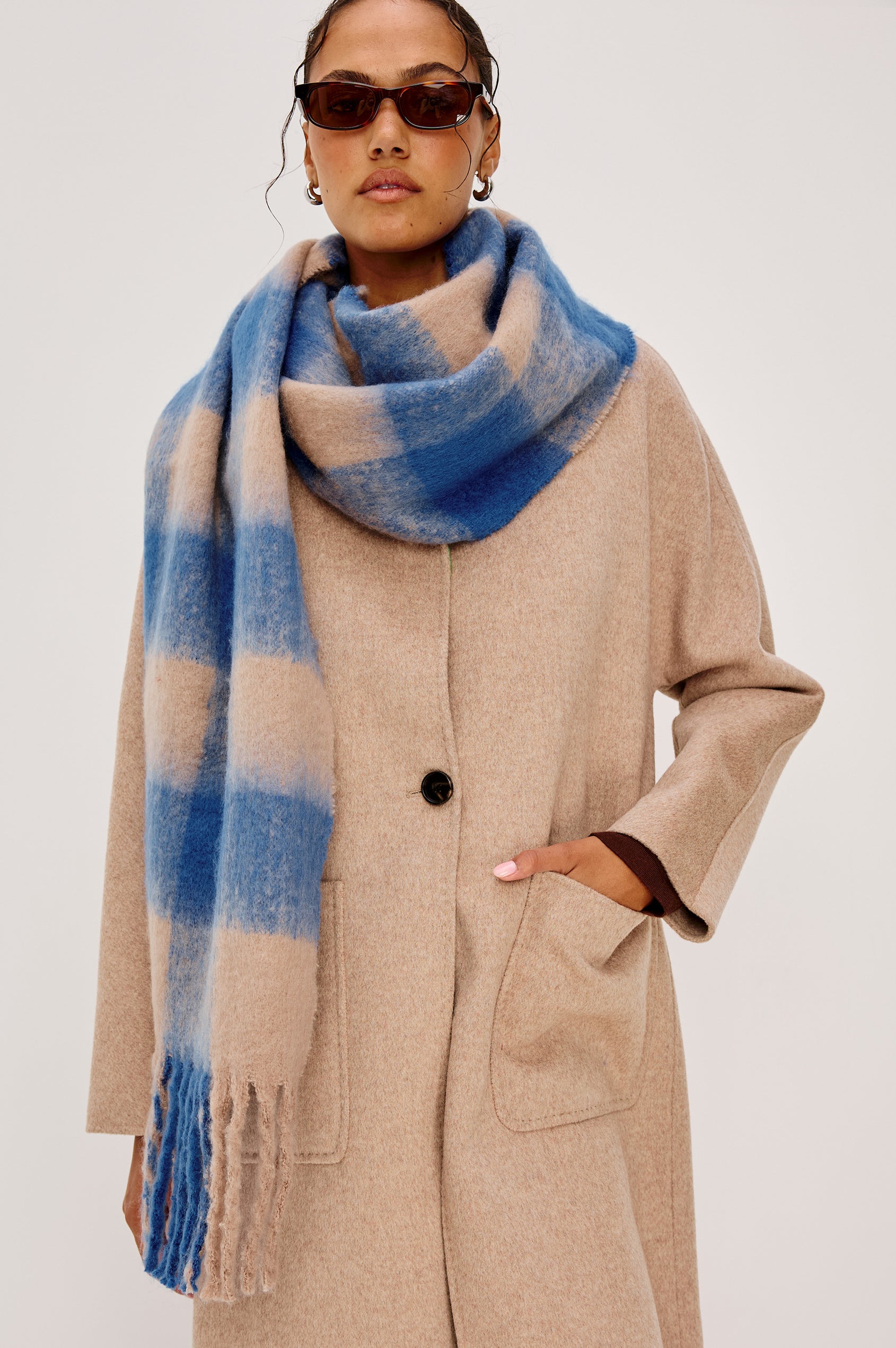 Oslo Scarf with Twisted Tassels and a Checkered Pattern in Cobalt Camel Colorway - Front View Featured on Model
