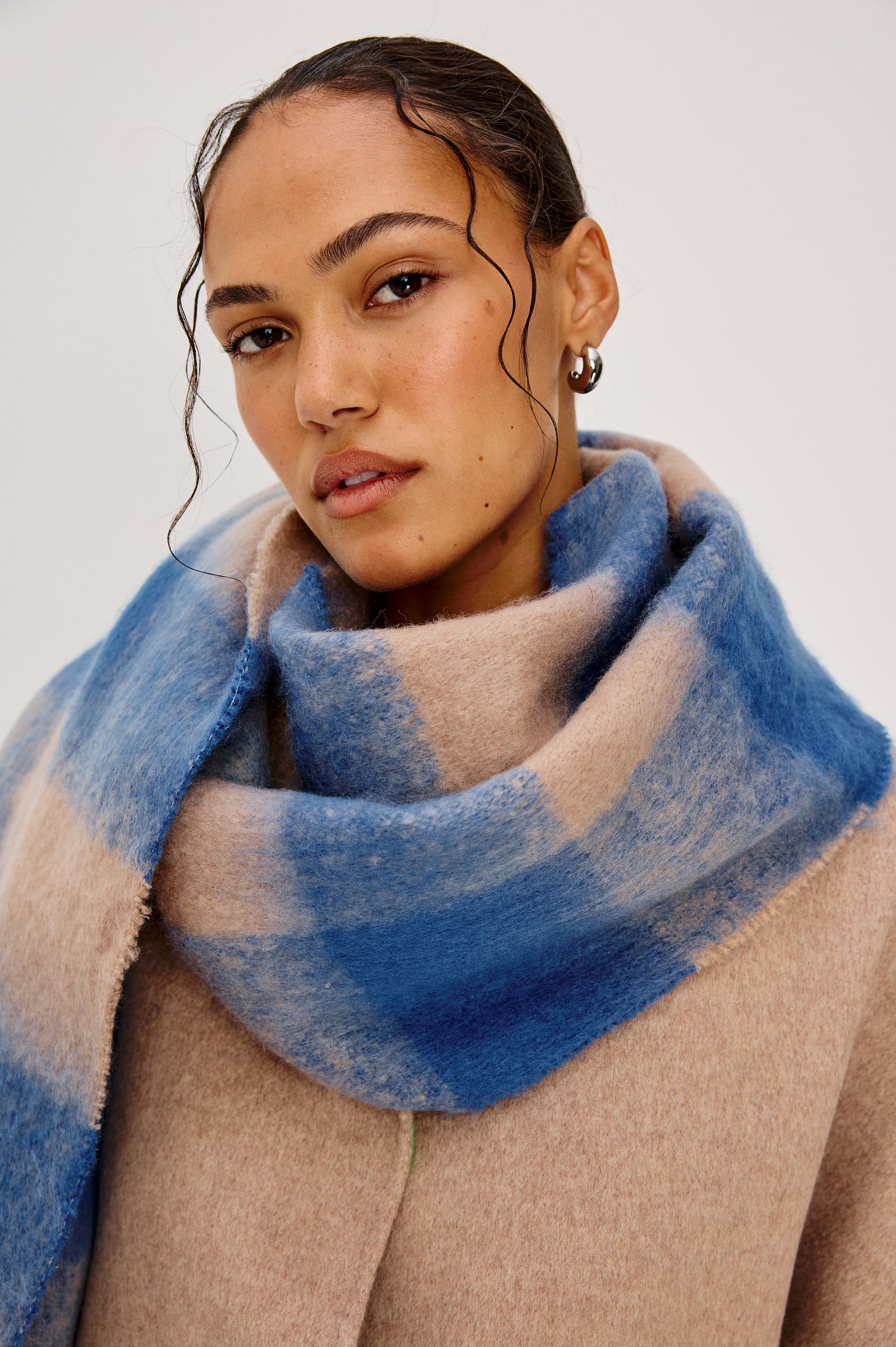 Oslo Scarf with Twisted Tassels and a Checkered Pattern in Cobalt Camel Colorway - Front Detail View Featured on Model