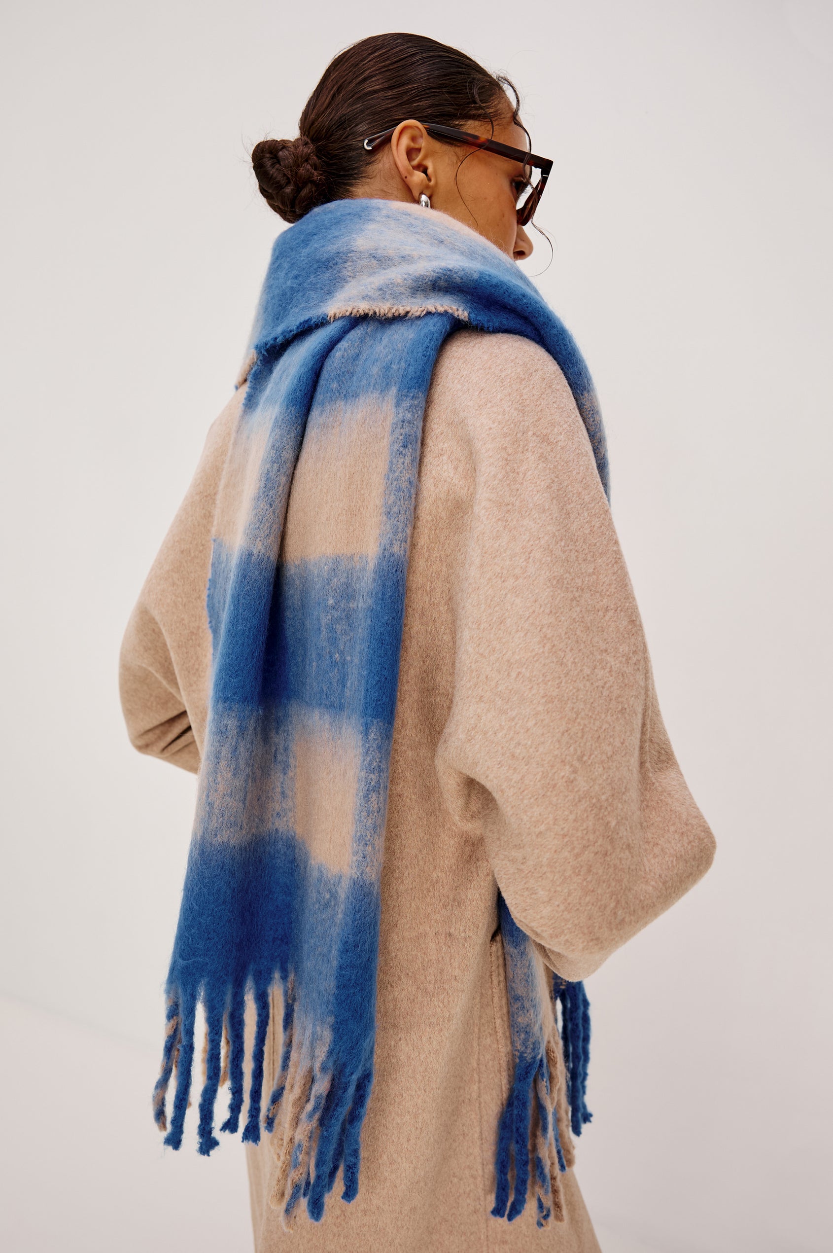 Oslo Scarf with Twisted Tassels and a Checkered Pattern in Cobalt Camel Colorway - Back View Featured on Model