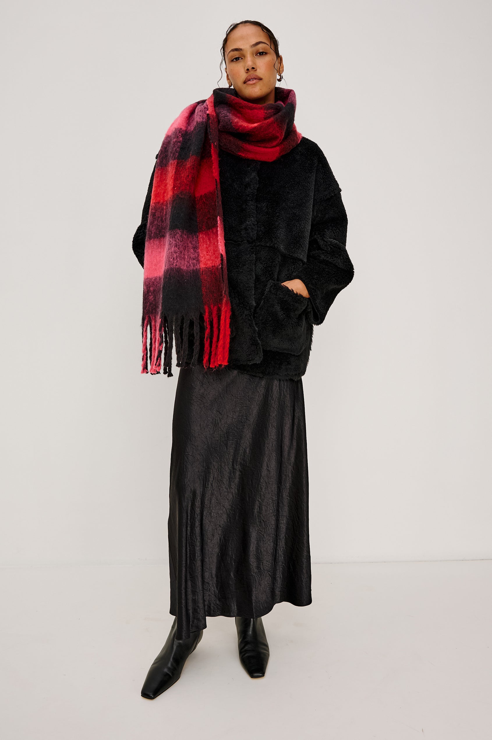 Oslo Scarf with Twisted Tassels and a Checkered Pattern in Charcoal Black Colorway - Front Full Body View Featured on Model