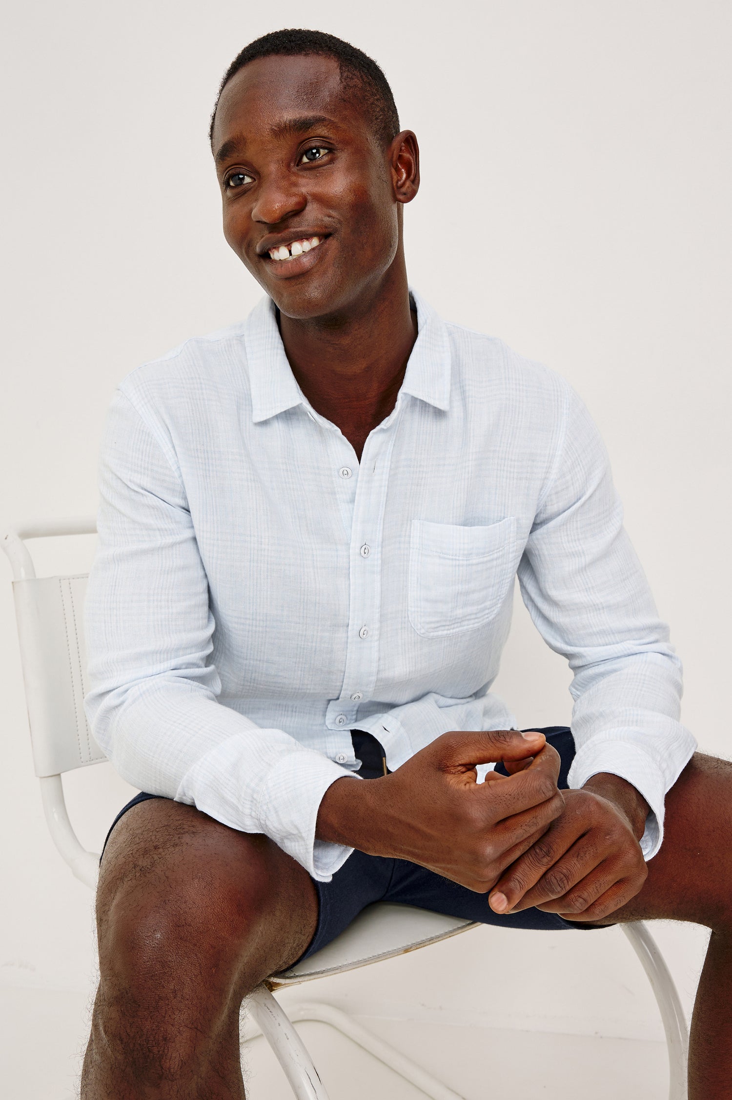 Owens Button-Up Shirt in Lightweight Cotton With Subtle Texture, Collar, Long Sleeves, and Chest Patch Pocket in Coastal Mist Colorway - Full Body View Featured on Model Sitting