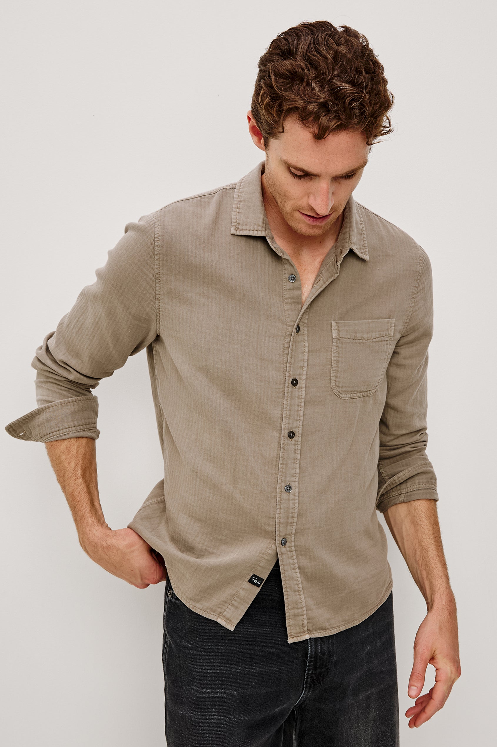 Owens is a long sleeve, collared, button front shirt lightweight cotton, long sleeve, and features a subtle pattern variation on the backside of the fabric in Desert Path colorway. Front view featured on model.
