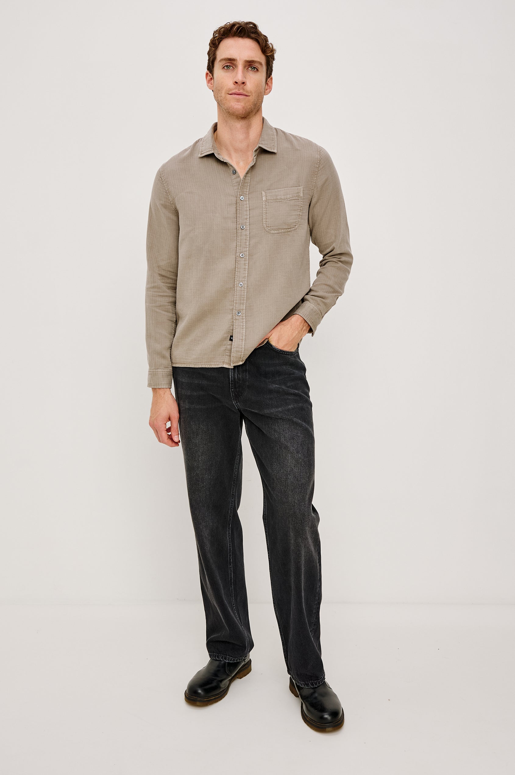 Owens is a long sleeve, collared, button front shirt in lightweight cotton, long sleeve, and features a subtle pattern variation on the backside of the fabric in Desert Path colorway. Front full body view featured on model.