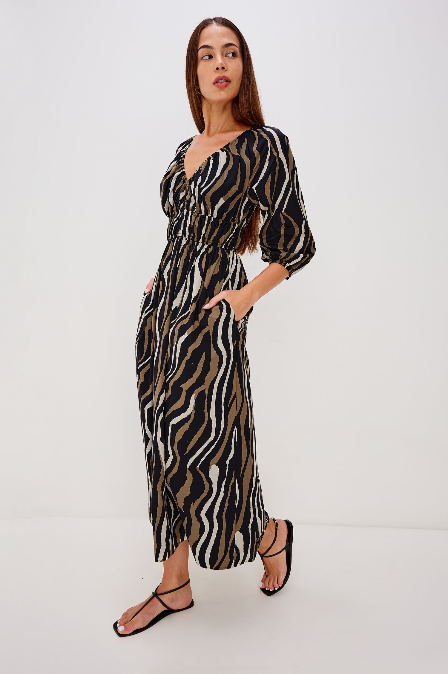 Paio Maxi Dress in Beach Cotton With Absract Print, V-neckline, Front Keyhole Cutout, Long Sleevees With Fitted Cuffs, and Three-Quarter in Canyon Stripe Colorway - Full Body Side View Featured on Model