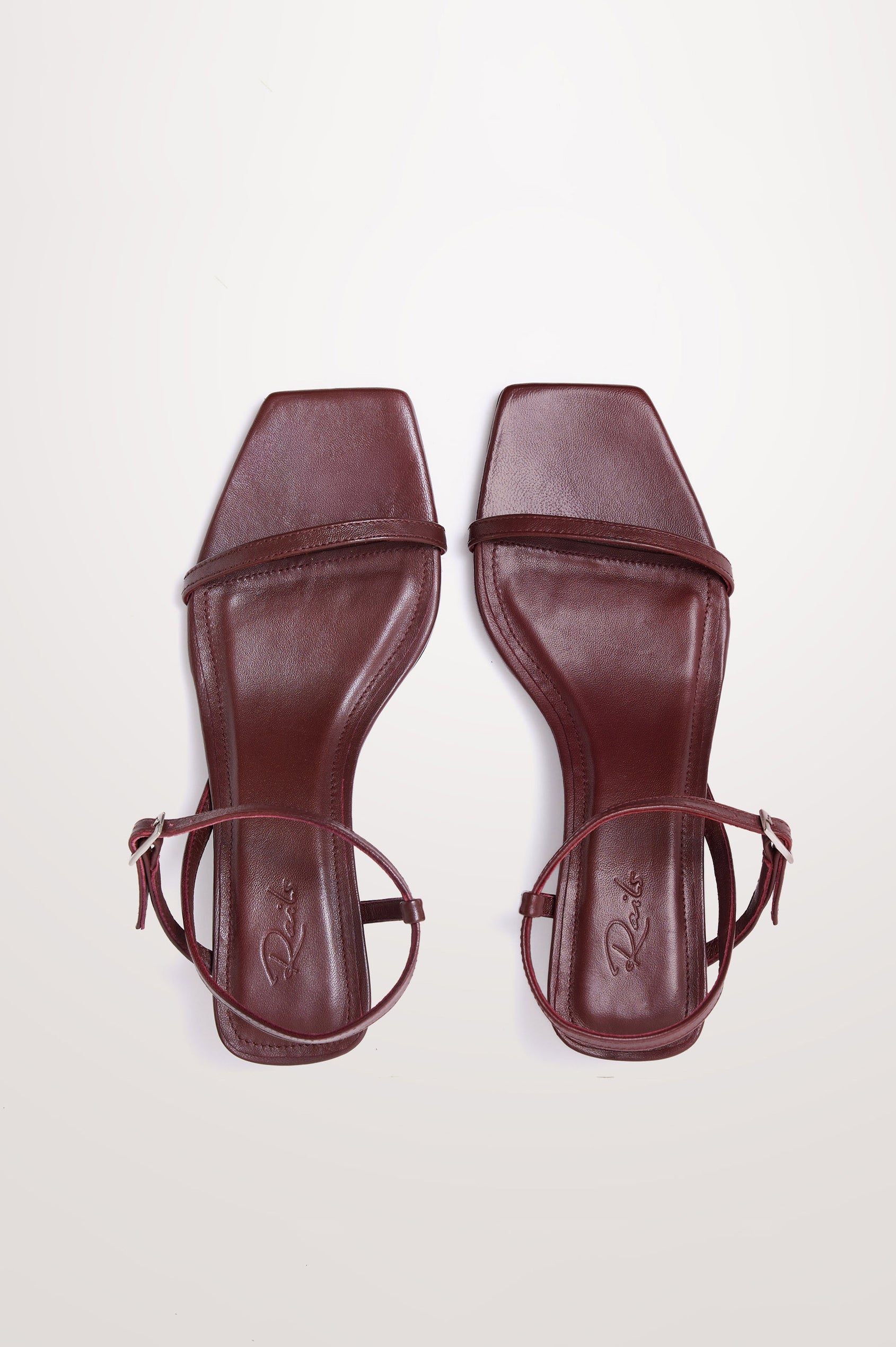 Palma Sandal Heel in Top-Grain Leather With Single Toe Strap, Adjustable Buckled Wrap Ankle Strap, and Low Heel in Burgundy Colorway - top view of shoe.