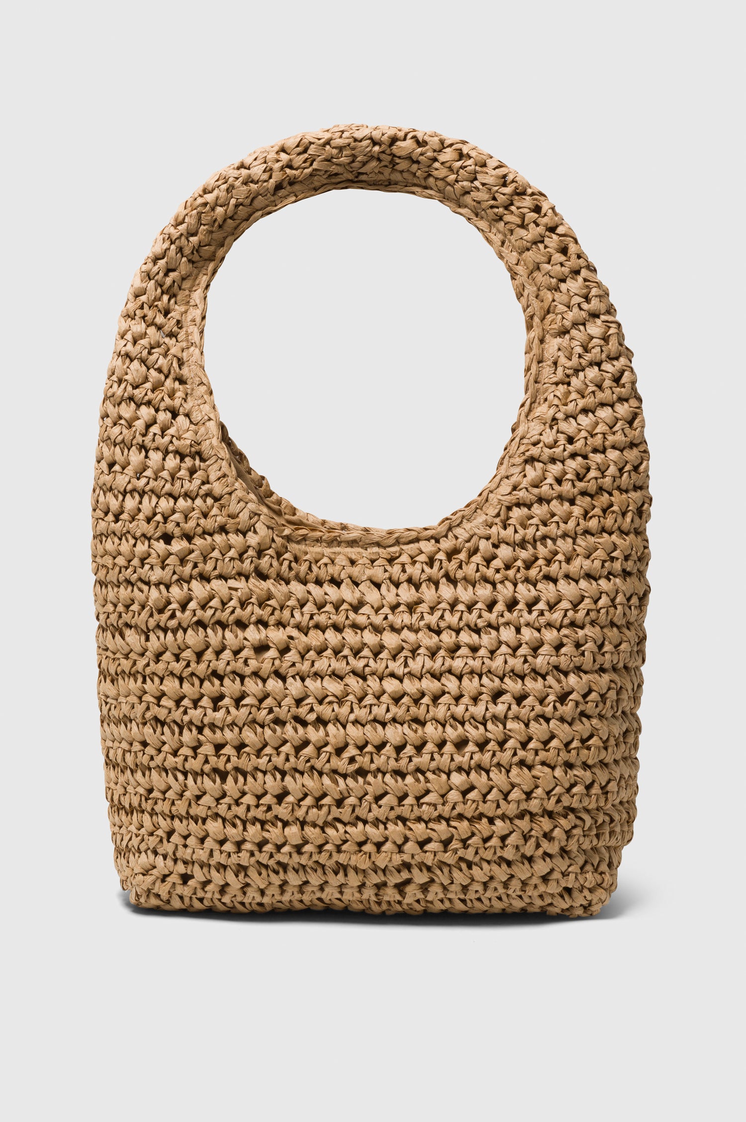 Palma Rattan Shoulder Bag with a Snap Closure and an Interior Pocket in Tan Colorway. Side view of Bag.