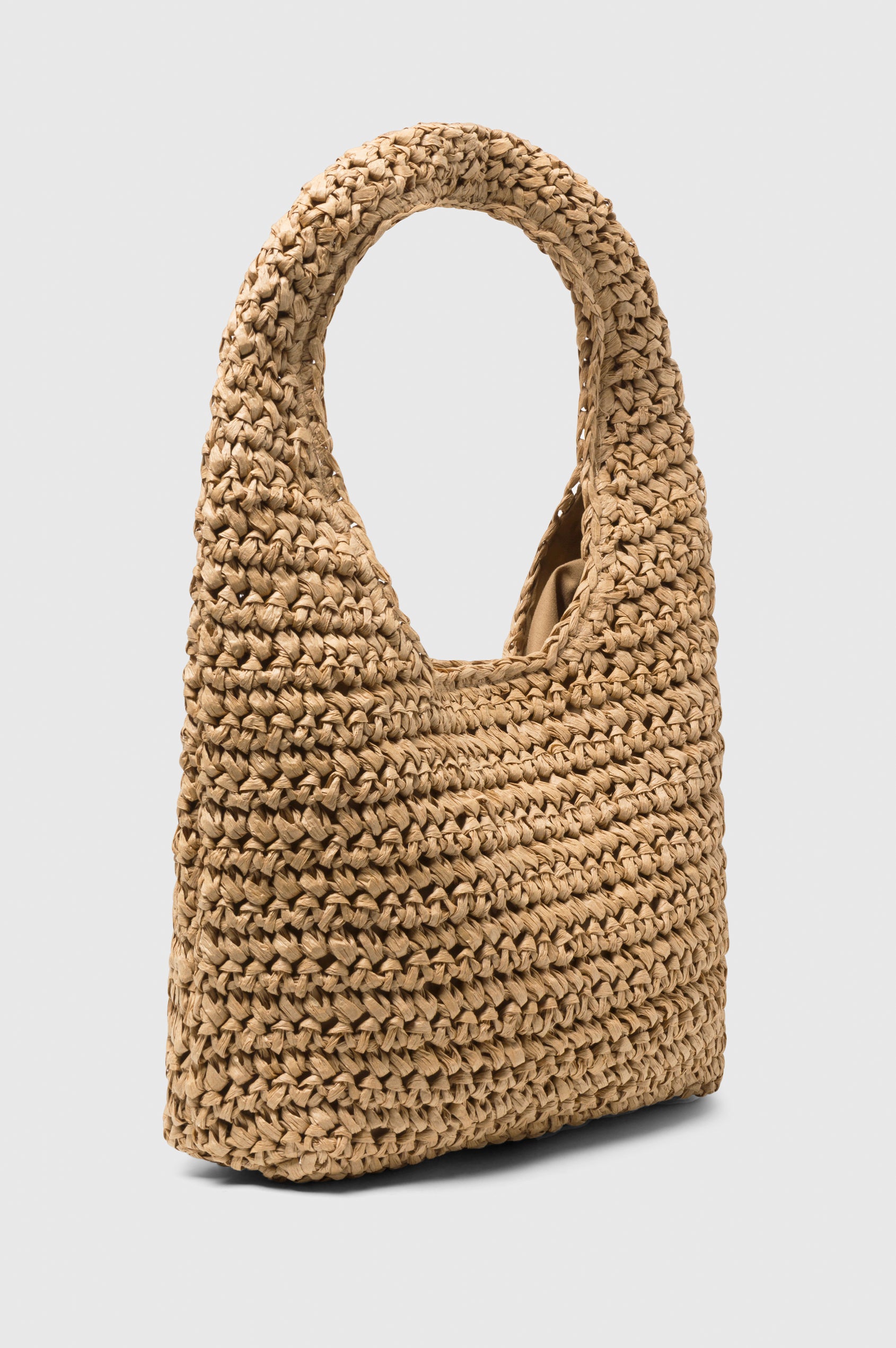 Palma Rattan Shoulder Bag with a Snap Closure and an Interior Pocket in Tan Colorway. Side View of Bag.
