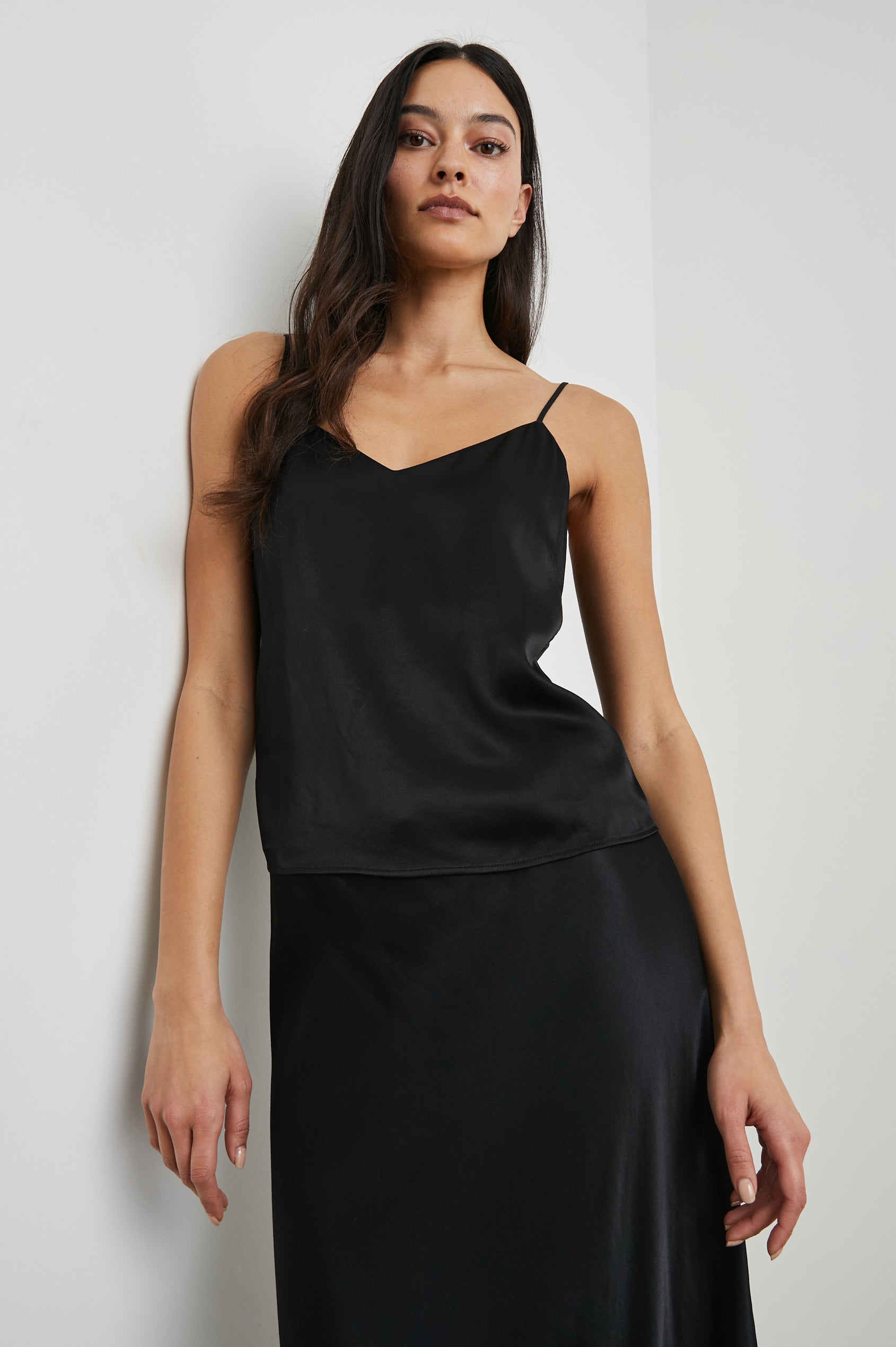 Paola Tank Top with a Deep V Neck and Adjustable Spaghetti Straps in Black Colorway - Front View Featured on Model