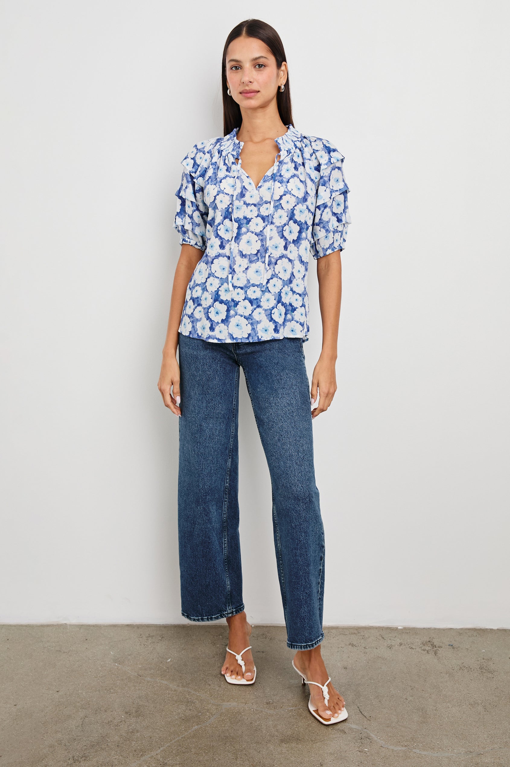 Paris Short-Sleeve Top with Shirred Collar, V-neckline with Ties, Deep Pleats on Sleeves and Elastic at the Sleeve Opening in Blue Floral Colorway, Blues and White - Front Untucked Full Body View Featured on Model