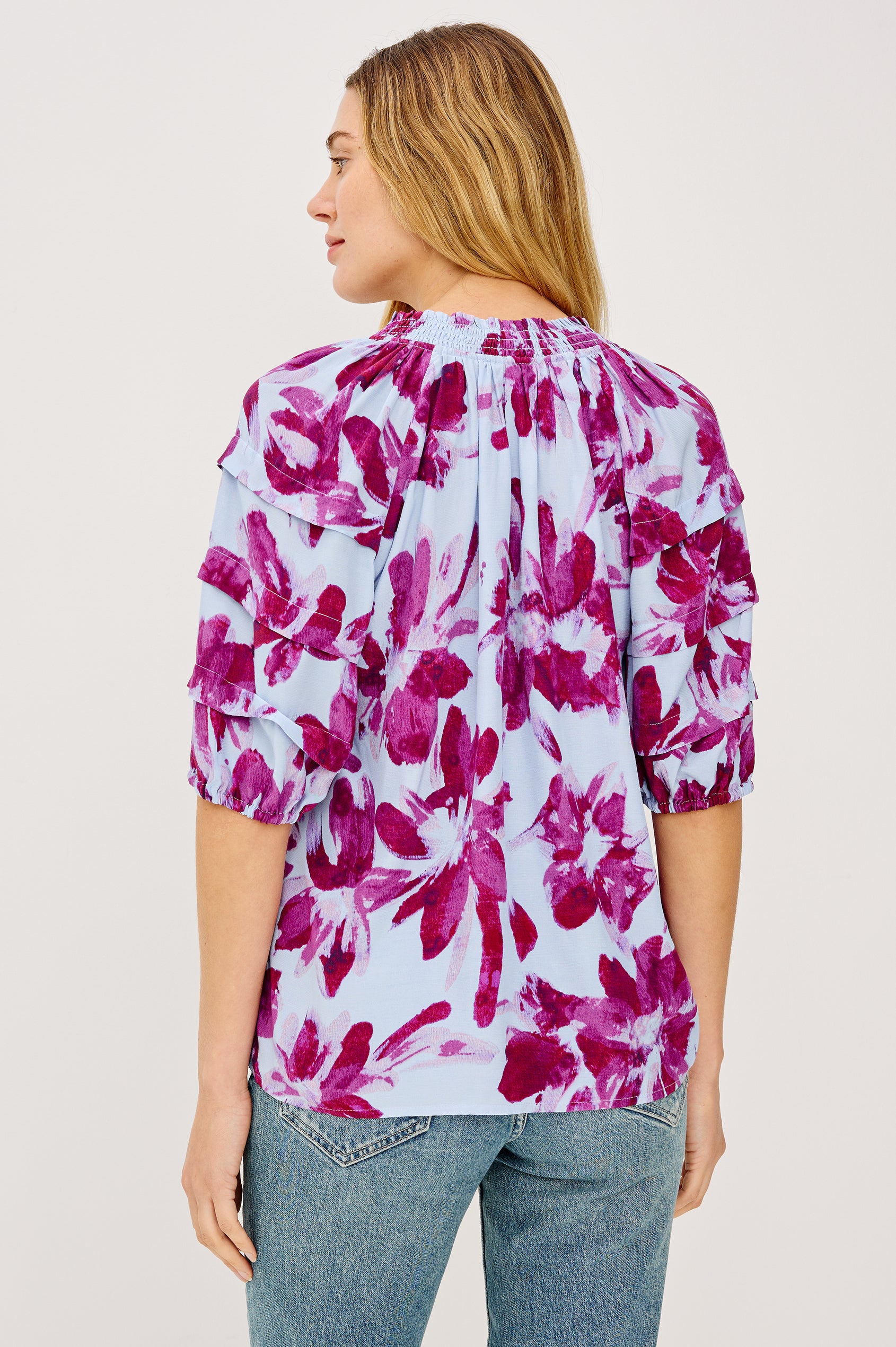 Paris Short-Sleeve Top with Shirred Collar, V-neckline with Ties, Deep Pleats on Sleeves and Elastic at the Sleeve Opening in Blue Lily Colorway, Blues and Pink- Back View Featured on Model