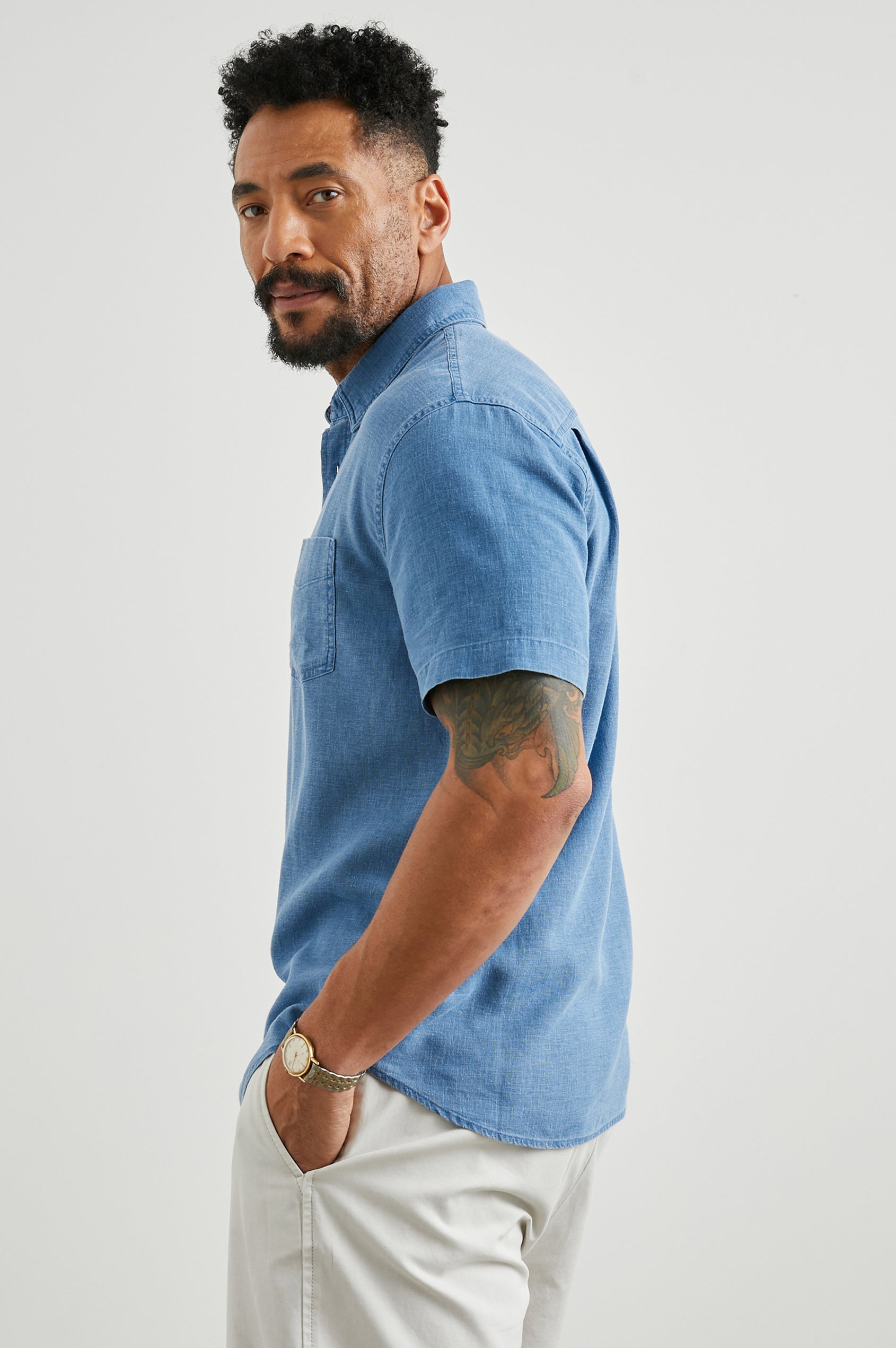 Paros Short-Sleeve Button Up with a Chest Patch Pocket in Celsius Colorway, a Blue - Side View Featured on Model