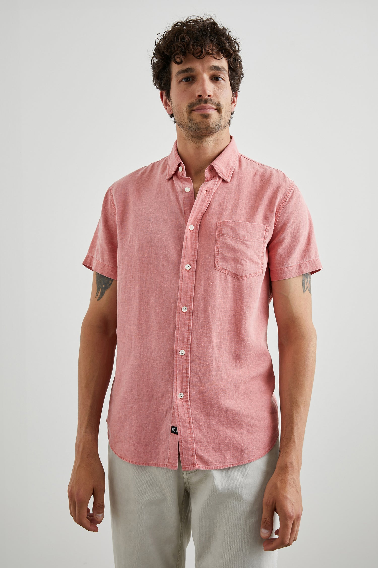 Paros Short-Sleeve Button Up with a Chest Patch Pocket in Equator Colorway, a Pink - Front View Featured on Model