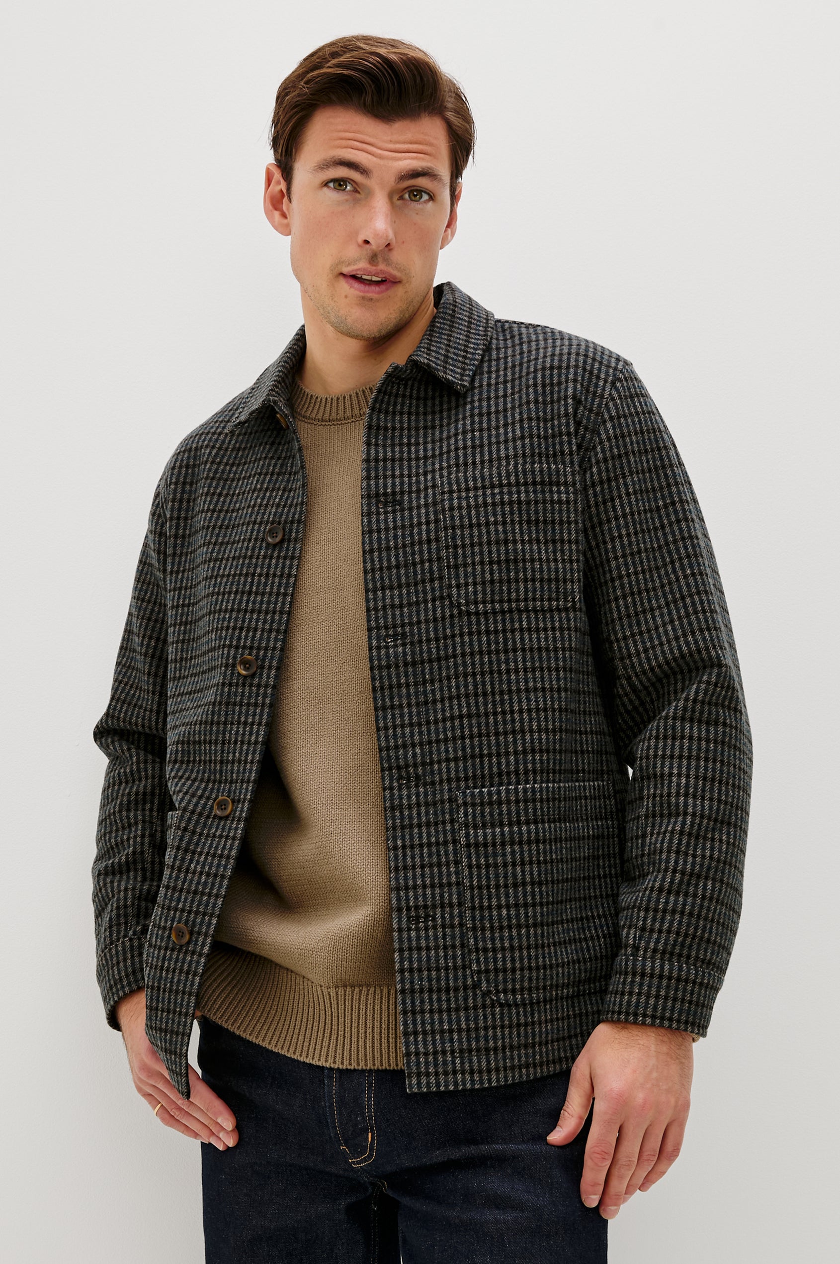 The Pascal is a collared button front jacket with front patch pockets and a chest pocket in Grey Check Plaid colorway. Front view featured on model.