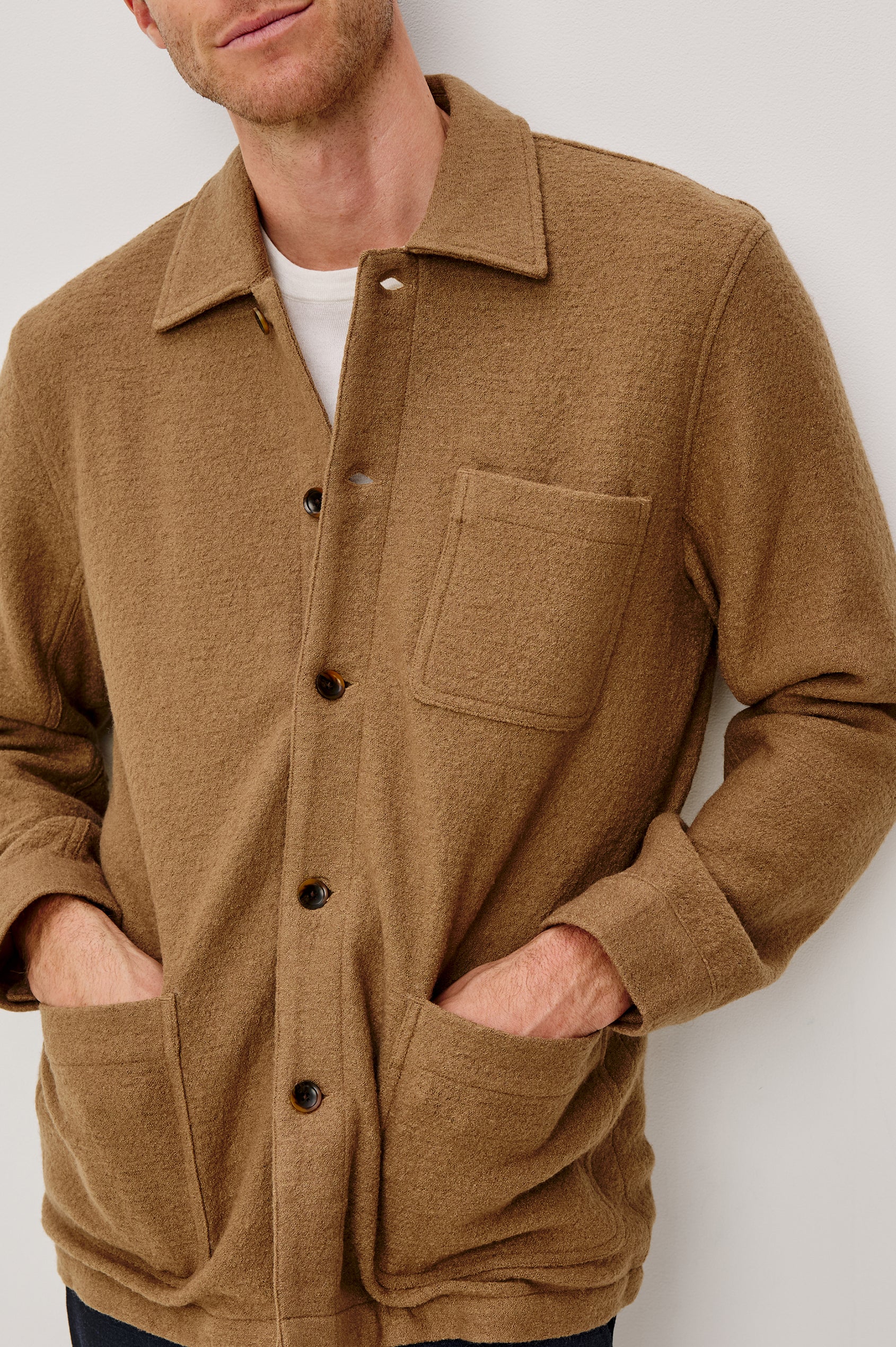 The Pascal is a collared button front jacket with front patch pockets and a chest pocket in Light Brown Boucle colorway. Front detail view featured on model.