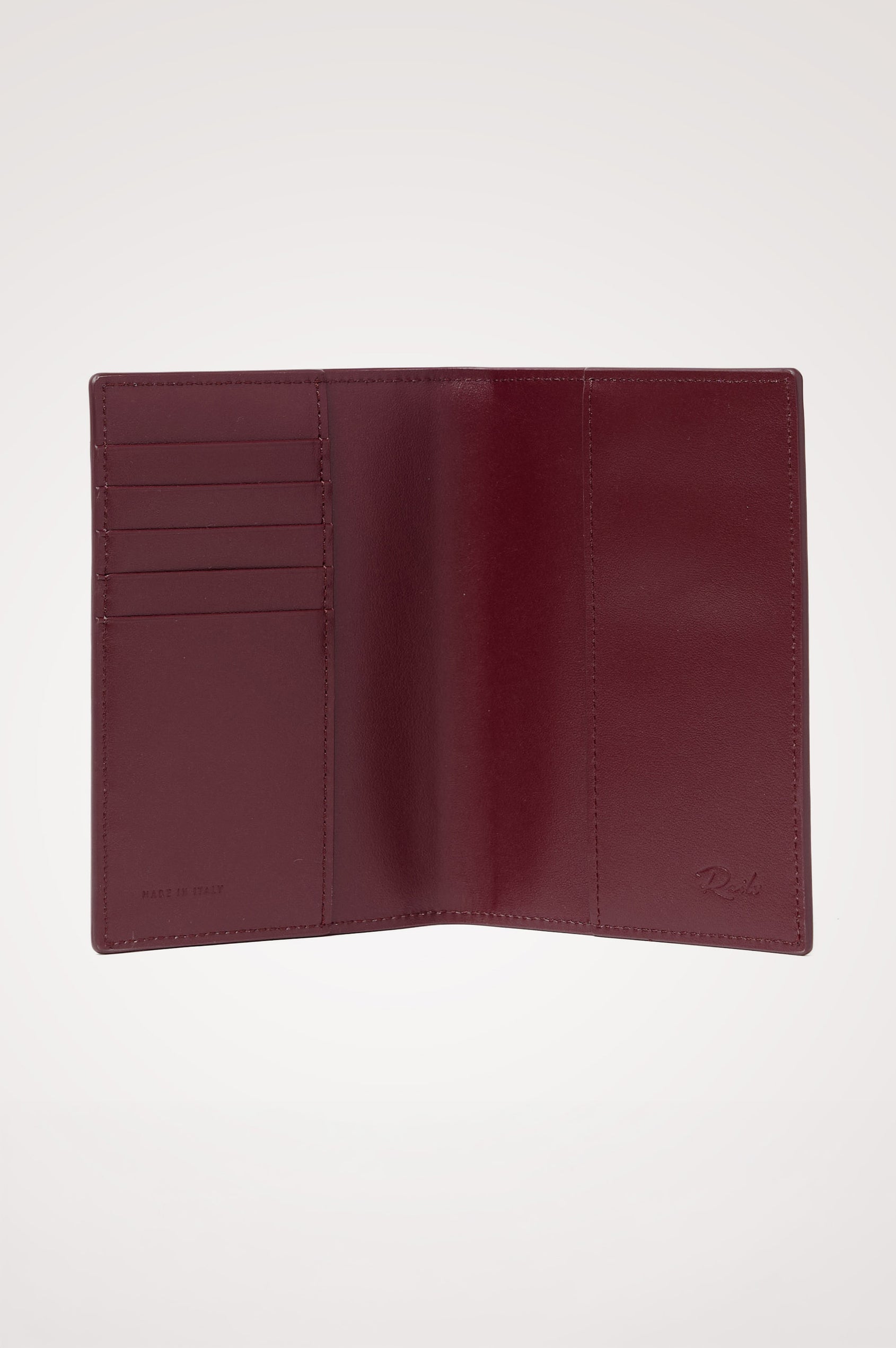 Passport Holder in Croc-Embossed Spanish Leather With Five Card Slots, Two Side Pockets, and Embossed Rails Logo in Burgundy Croc Embossed Colorway - Interior view.