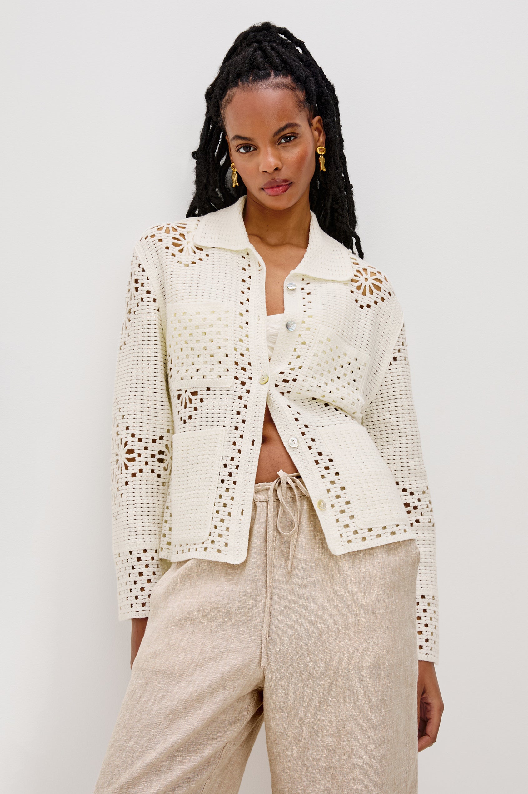 Patmos Collared Button Front Sweater Cardigan with Long Sleeves and Four Front Patch Pockets in Ivory Colorway. Front View Shown on Model.