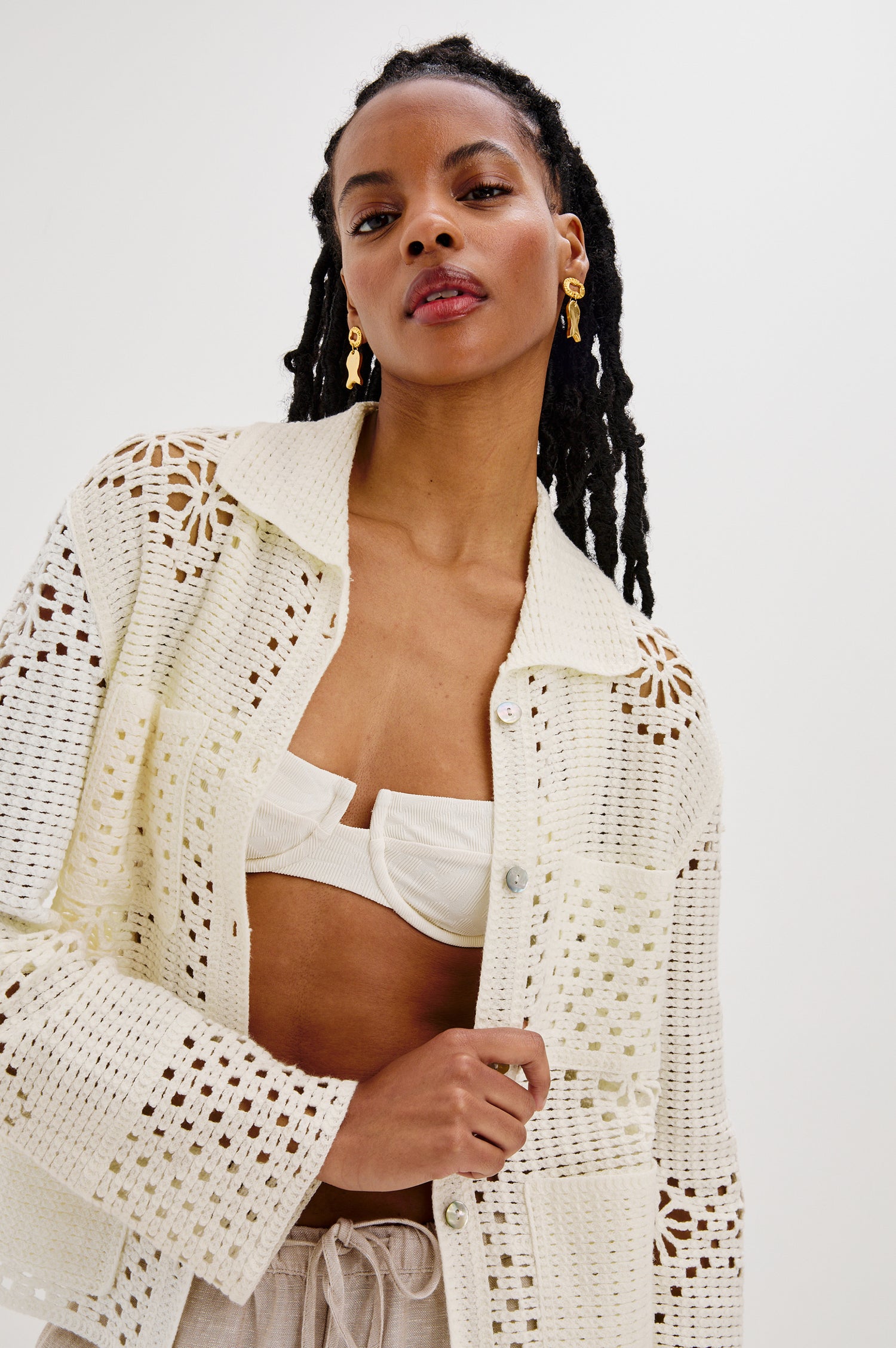 Patmos Collared Button Front Sweater Cardigan with Long Sleeves and Four Front Patch Pockets in Ivory Colorway. Front View Shown on Model.