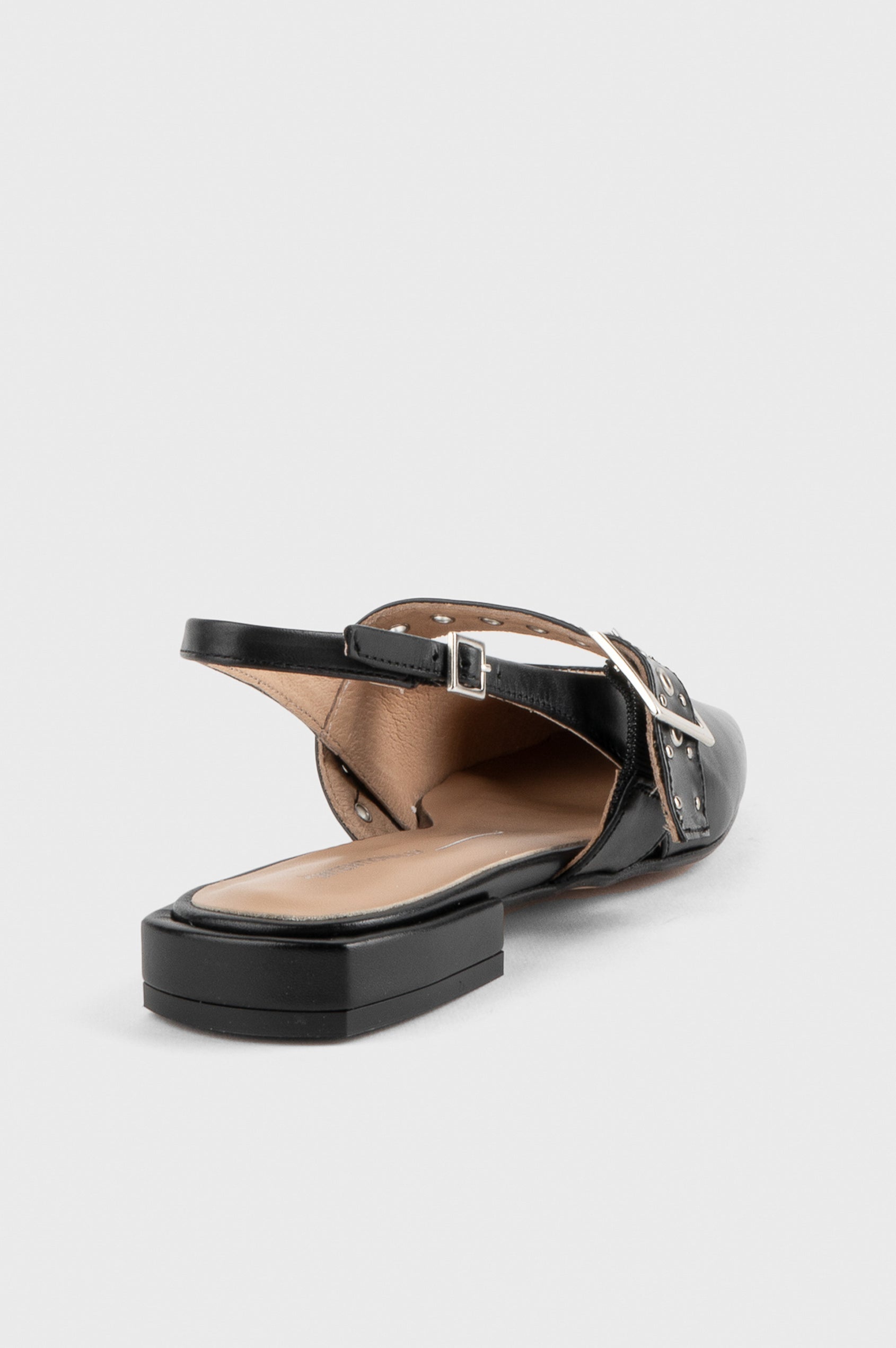 Intentionally Blank Pearl Ballet Flat with an Adjustable Slingback Strap, a Studded Upper Buckle Strap, a Small Heel and a Square Toe in Black Colorway - close up of ankle details, single shoe