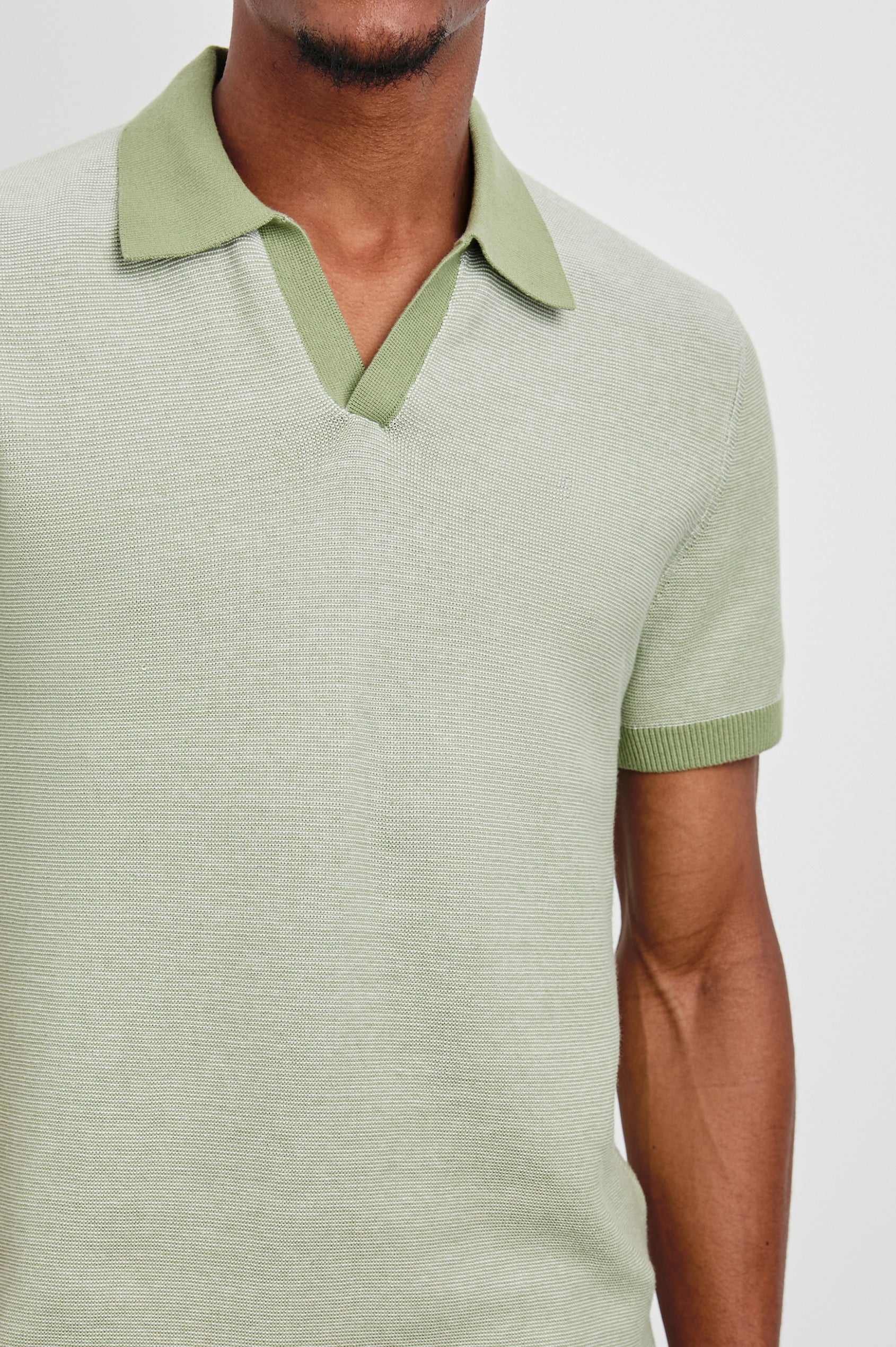 Pearson Short-Sleeve Polo Shirt with a Buttonless Placket in Fern Colorway, with a collar and trim in a darker green - Front View Featured on Model